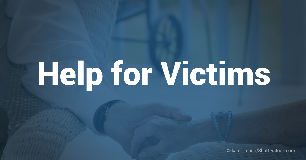  A blue background with white text that reads 'Help for Victims' with a close up of two people holding hands.