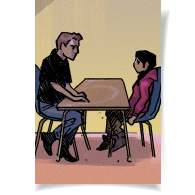 A young boy sitting at a table speaking with an adult