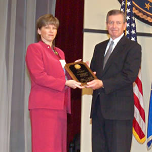 Lynn Shiner receives a National Crime Victim Service Award from John Ashcroft