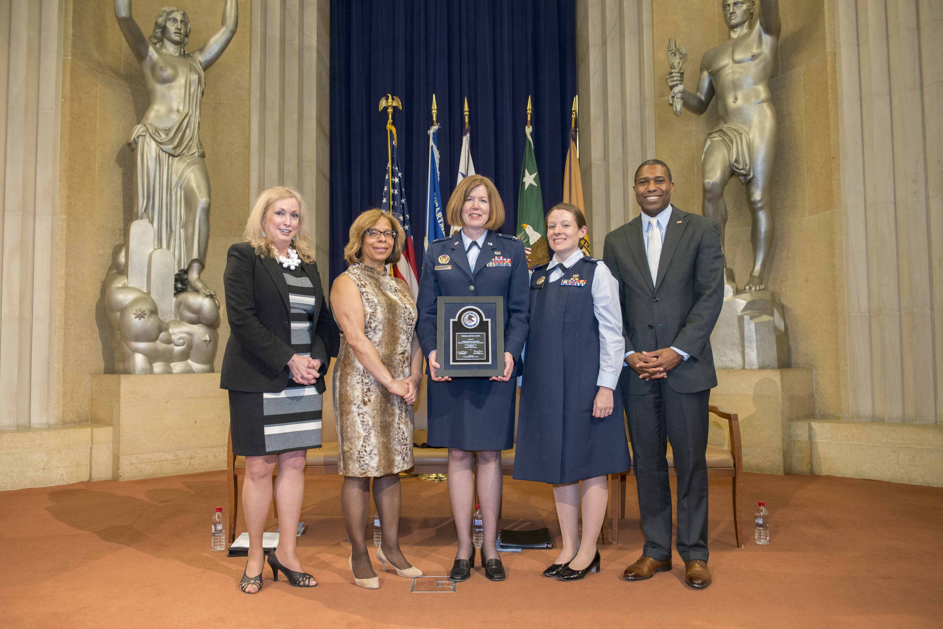 Colonel Dawn Hankins and Captain Allison DeVito accept the 2014 Federal Service Award for the U.S. Air Force Special Victims' Counsel Program, with Joye E. Frost, Director, Office for Victims of Crime; Karol V. Mason, Assistant Attorney General, Office of Justice Programs; and Associate Attorney General Tony West.