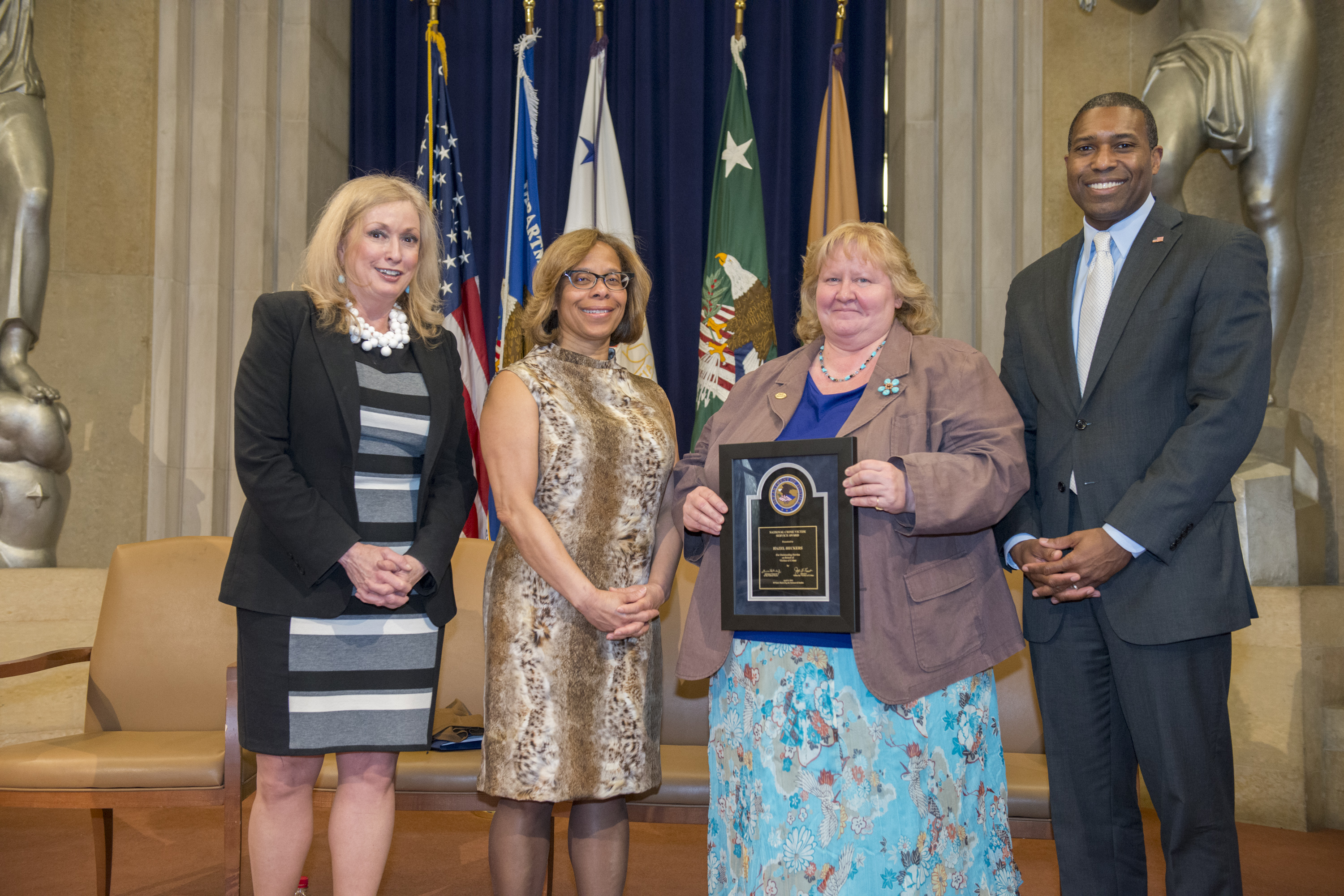 2014 National Crime Victim Service Award recipient Hazel Heckers with (from left) Joye E. Frost, Director, Office for Victims of Crime; Karol V. Mason, Assistant Attorney General, Office of Justice Programs; and Associate Attorney General Tony West.