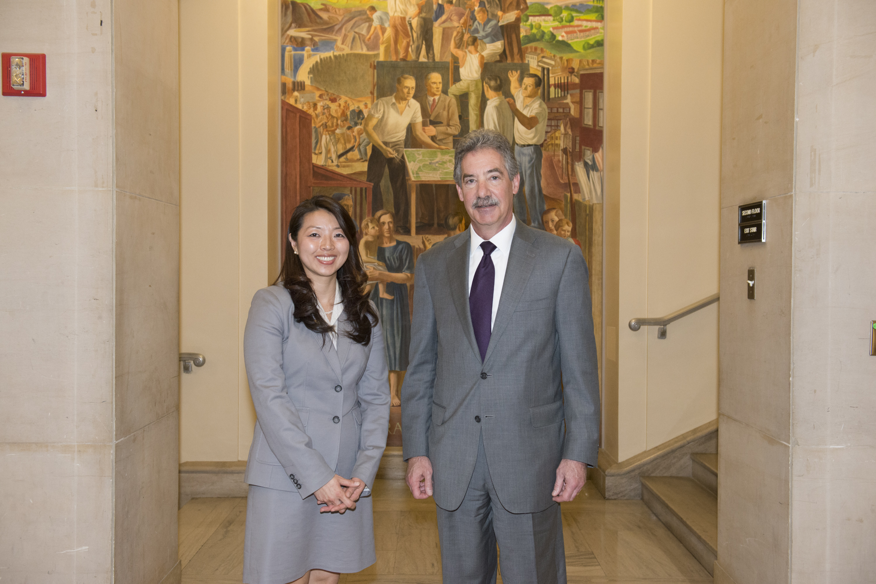 Mi Yung Claire Park, a 2014 Crime Victims Financial Restoration Award recipient, appears with Deputy Attorney General James M. Cole.