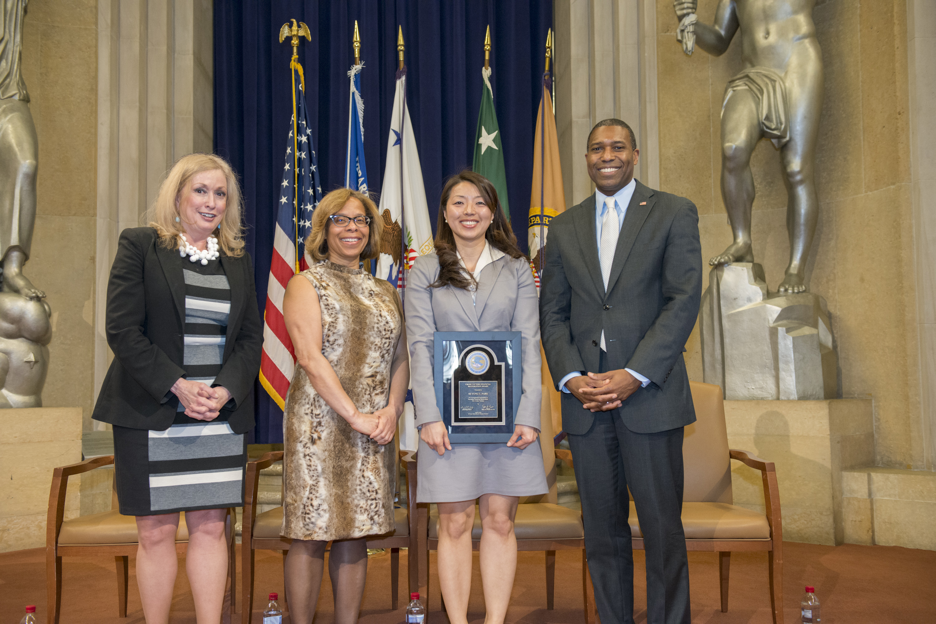 2014 Crime Victims Financial Restoration Award recipient Mi Yung Claire Park with (from left) Joye E. Frost, Director, Office for Victims of Crime; Karol V. Mason, Assistant Attorney General, Office of Justice Programs; and Associate Attorney General Tony West.