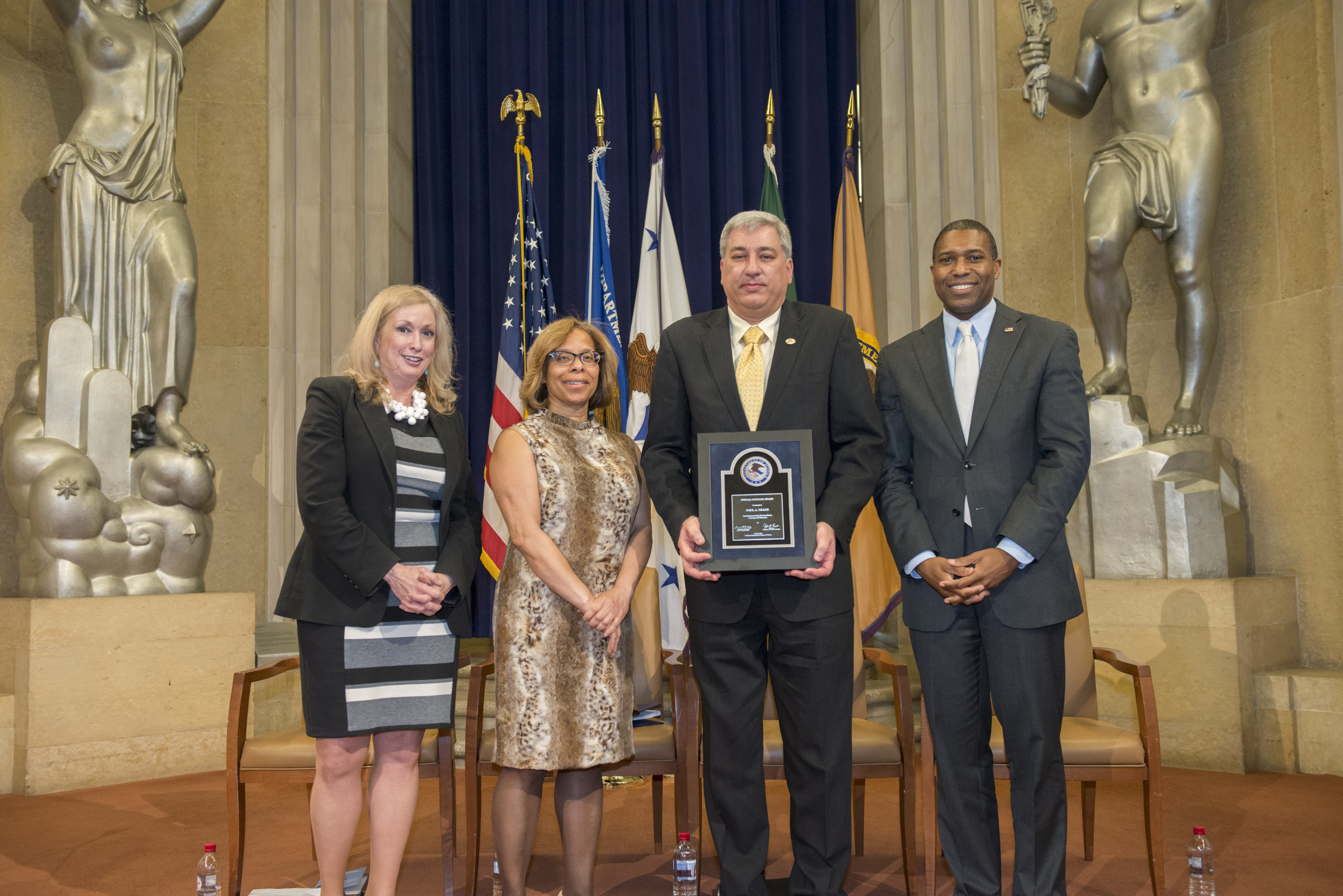 2014 Special Courage Award recipient Paul Traub with (from left) Joye E. Frost, Director, Office for Victims of Crime; Karol V. Mason, Assistant Attorney General, Office of Justice Programs; and Associate Attorney General Tony West.