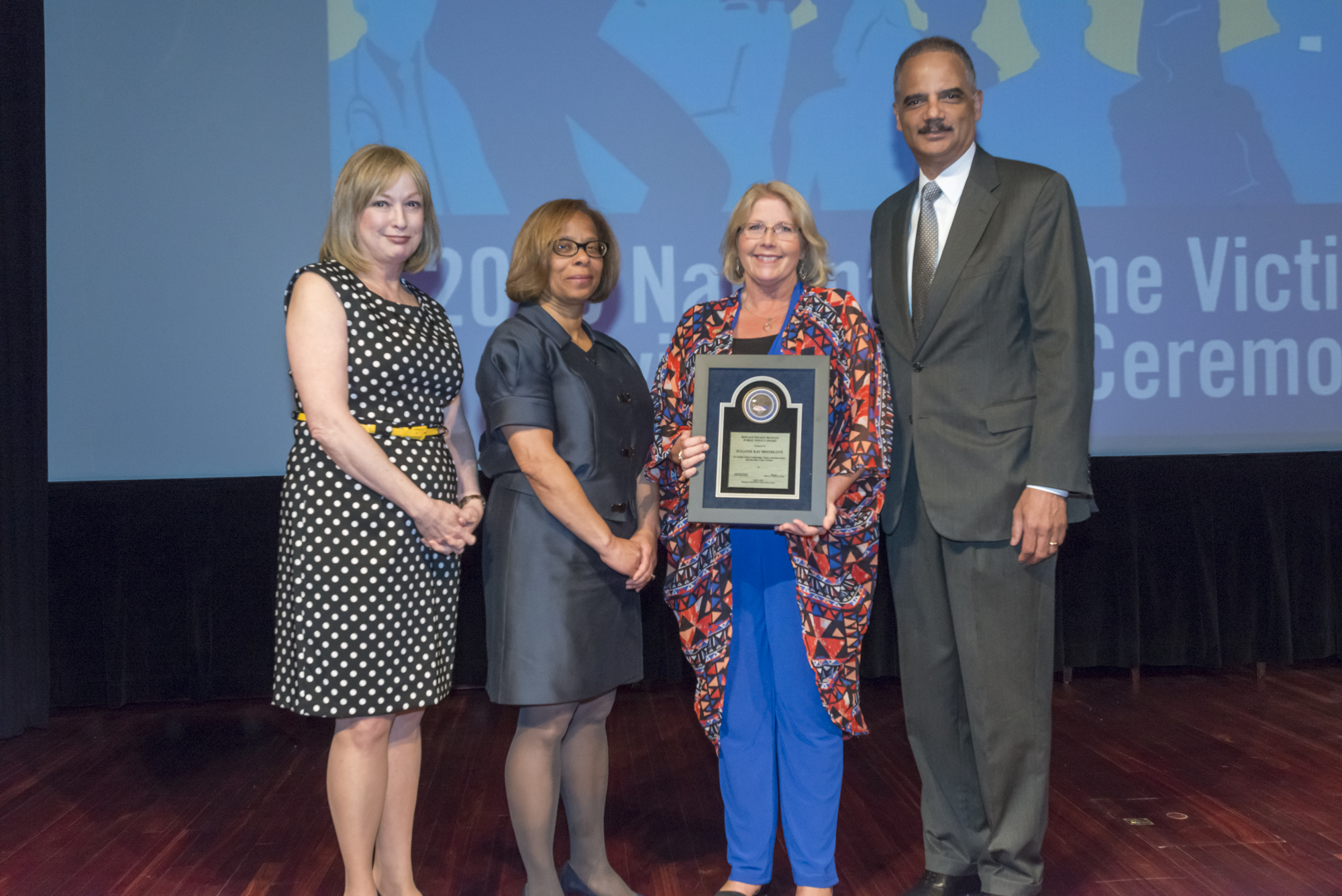 2015 National Crime Victim Service Award recipient Suzanne Kay Breedlove with (from left) Joye E. Frost, Director, Office for Victims of Crime; Karol V. Mason, Assistant Attorney General, and Attorney General Eric H. Holder, Jr.