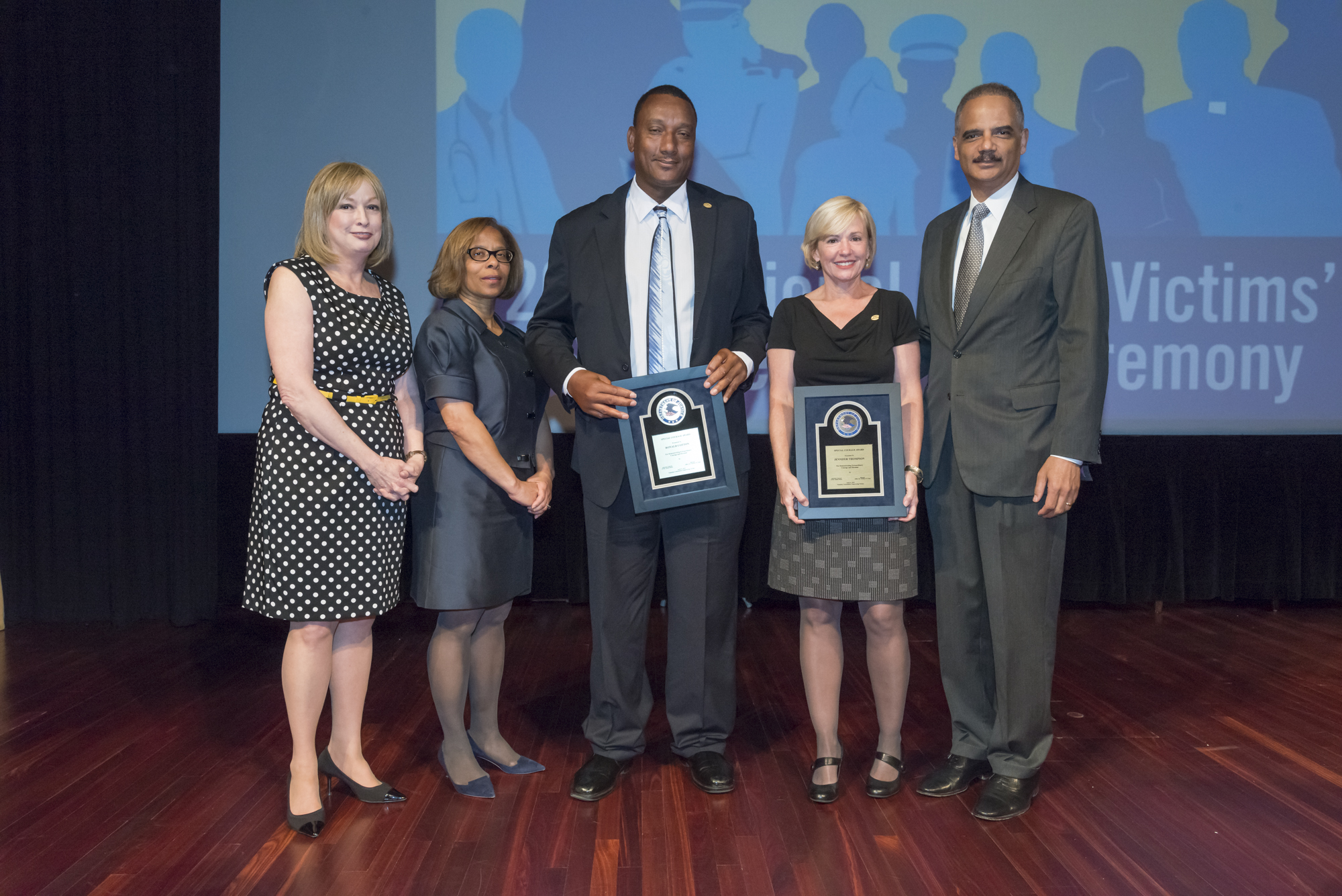 2015 National Crime Victim Service Award recipients Ronald Cotton and Jennifer Thompson with (from left) Joye E. Frost, Director, Office for Victims of Crime; Karol V. Mason, Assistant Attorney General, and Attorney General Eric H. Holder, Jr.