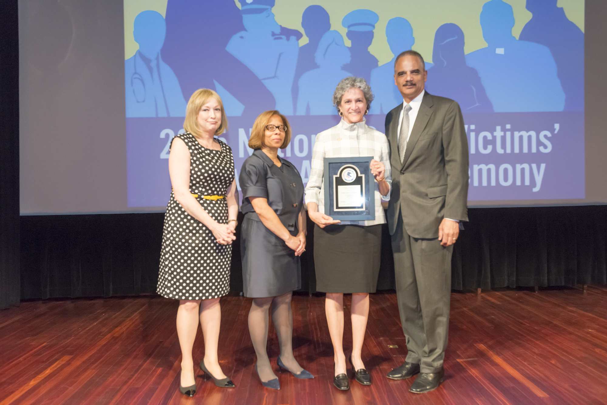 2015 National Crime Victim Service Award recipient Karen Irene Kalergis with (from left) Joye E. Frost, Director, Office for Victims of Crime; Karol V. Mason, Assistant Attorney General, and Attorney General Eric H. Holder, Jr.