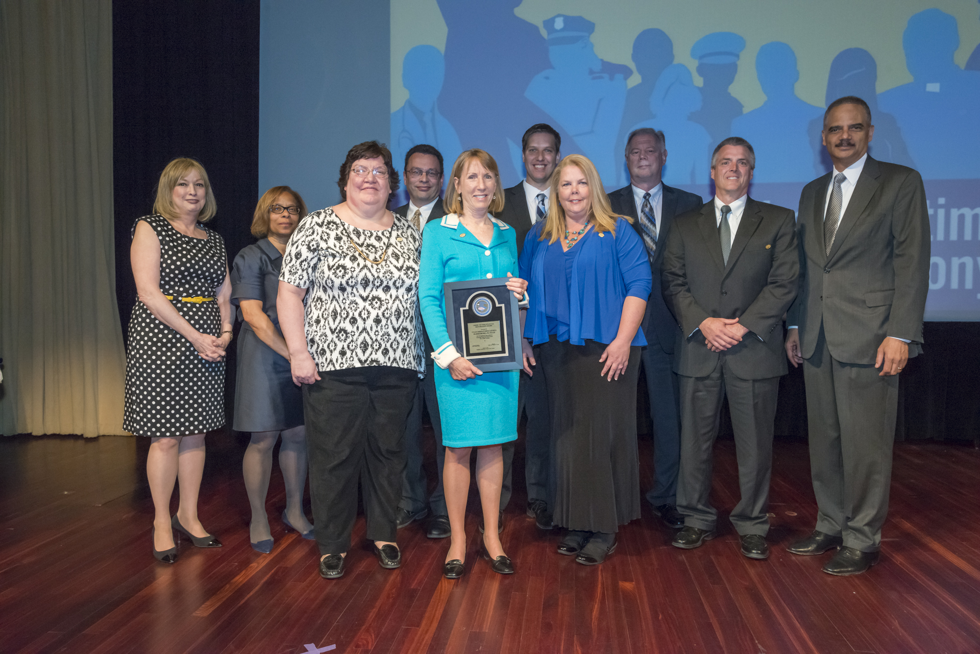 Staff from the U.S. Attorney’s Office-Middle District of Pennsylvania, U.S. Department of Justice Asset Forfeiture Money Laundering Section, and the U.S. Postal Inspection Service-Harrisburg, Pennsylvania accept the 2015 Crime Victim Financial Restoration Award with Joye E. Frost, Director, Office for Victims of Crime; Karol V. Mason, Assistant Attorney General, Office of Justice Programs; and Attorney General Eric H. Holder, Jr.