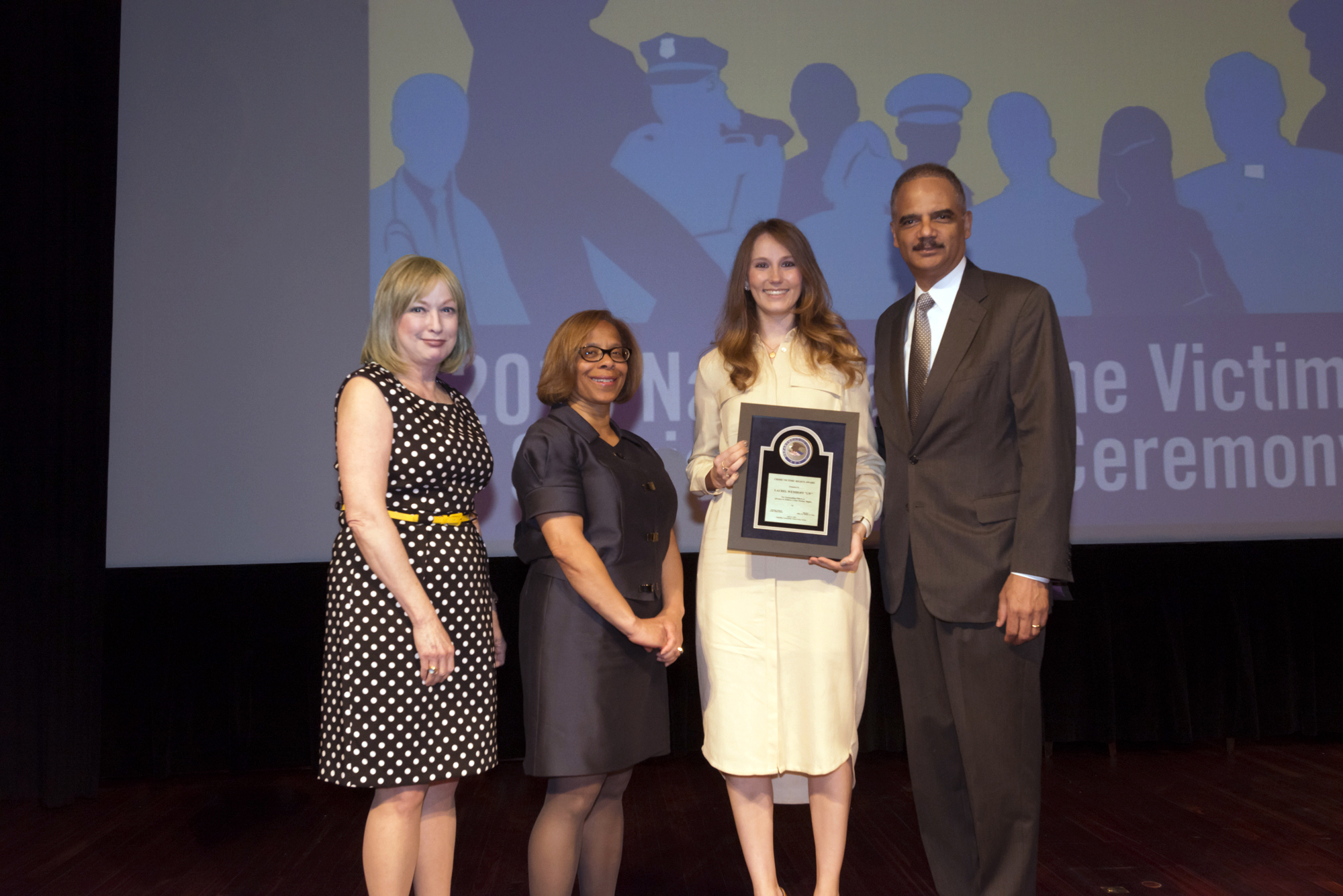 2015 National Crime Victim Service Award recipient Laurel Wemhoff with (from left) Joye E. Frost, Director, Office for Victims of Crime; Karol V. Mason, Assistant Attorney General, and Attorney General Eric H. Holder, Jr.