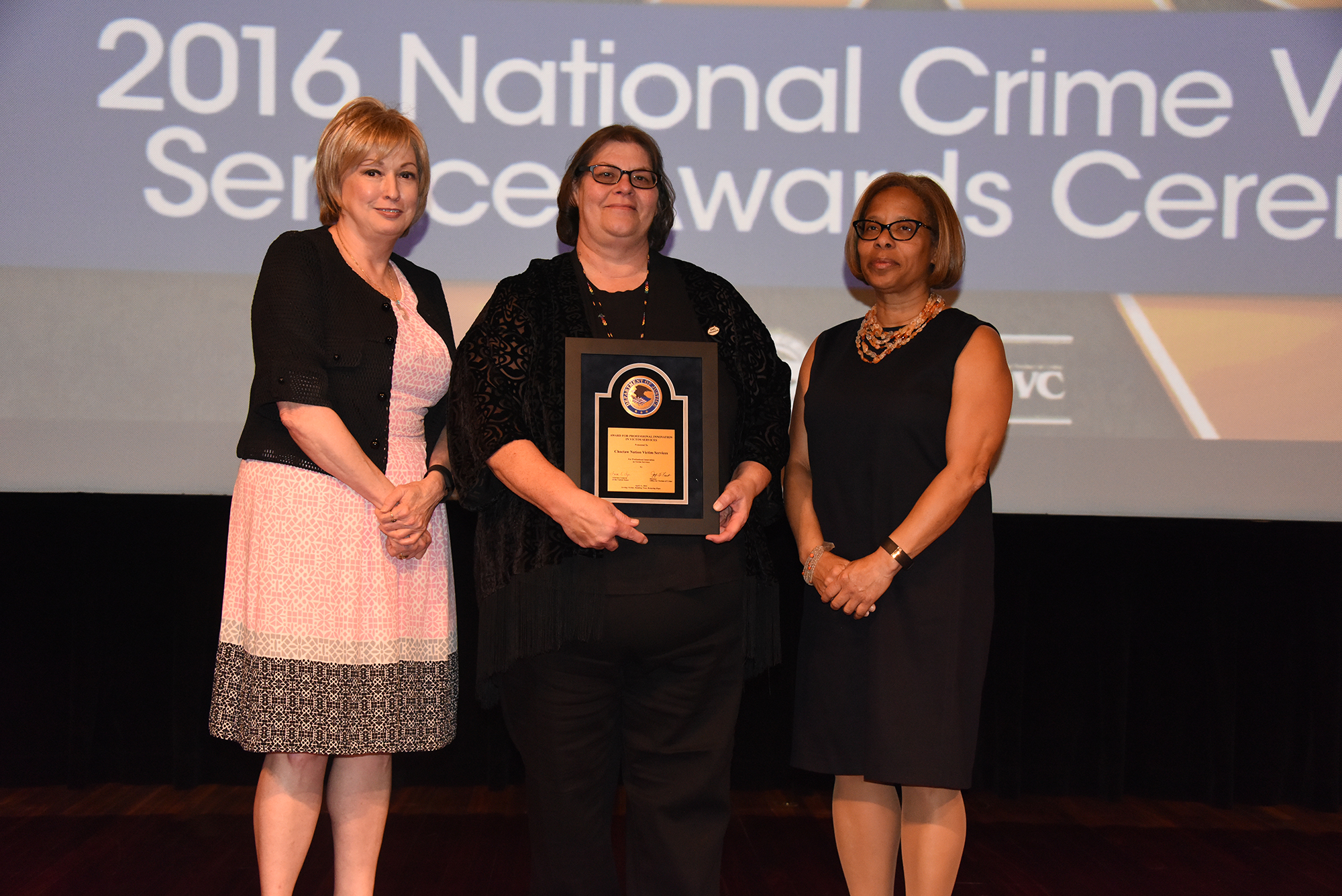 Linda Goodwin Sr. from Choctaw Nation Victim Services accepts the 2016 Award for Professional Innovation in Victim Services with (from left) Joye E. Frost, Director, Office for Victims of Crime; Karol V. Mason, Assistant Attorney General; and Attorney General Loretta E. Lynch.
