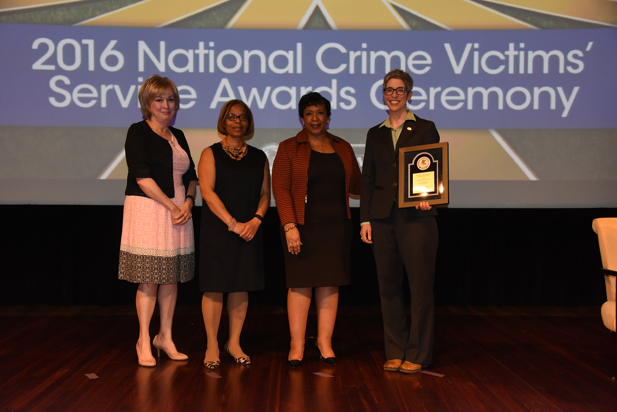 2016 Crime Victims Research Award recipient Anne P. DePrince, Ph.D. with (from left) Joye E. Frost, Director, Office for Victims of Crime; Karol V. Mason, Assistant Attorney General; and Attorney General Loretta E. Lynch.