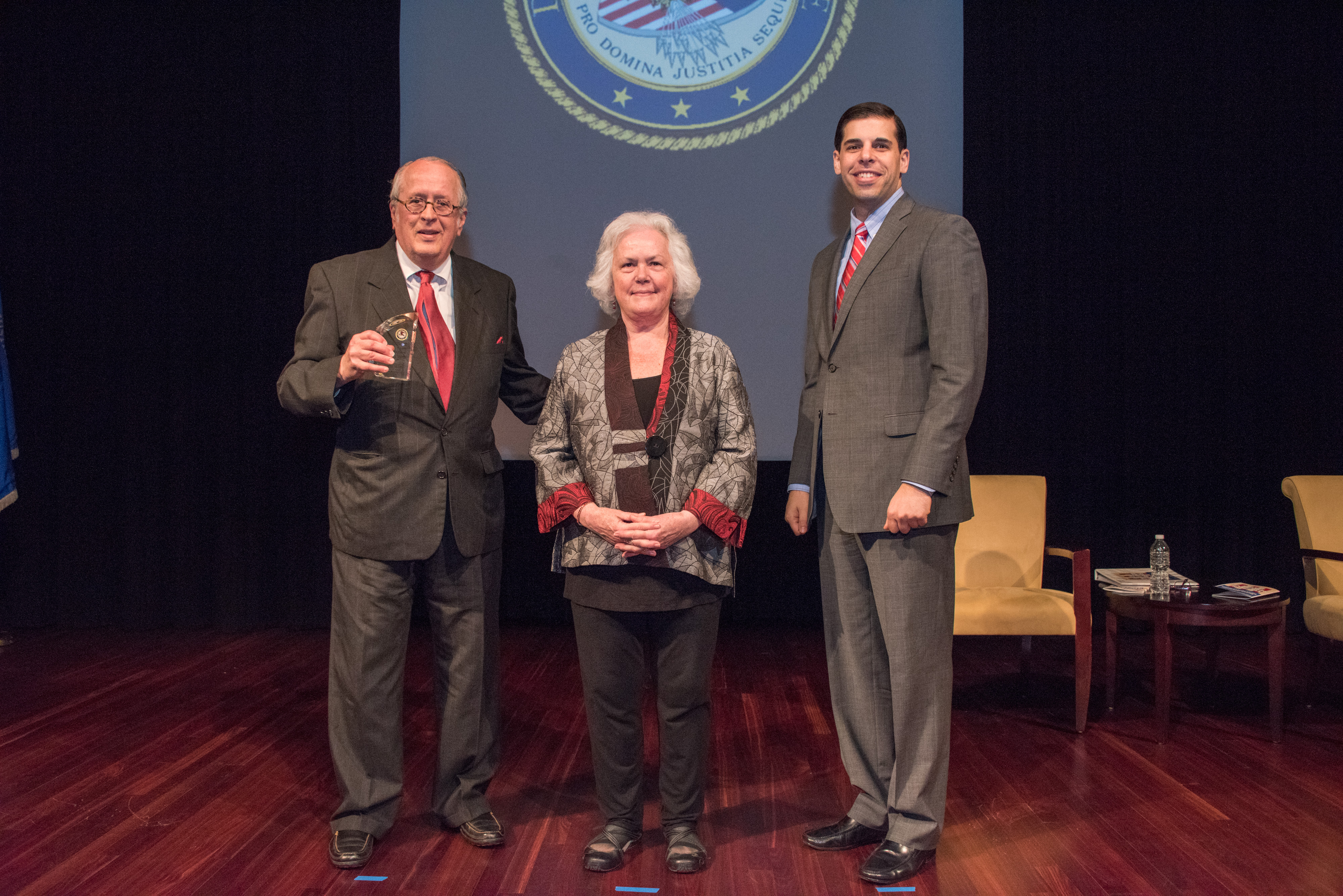2017 Ronald Wilson Reagan Public Policy Award recipient Kendall L. Carver with (from left) Acting OVC Director Marilyn McCoy Roberts and Acting Associate Attorney General Jesse Panuccio.