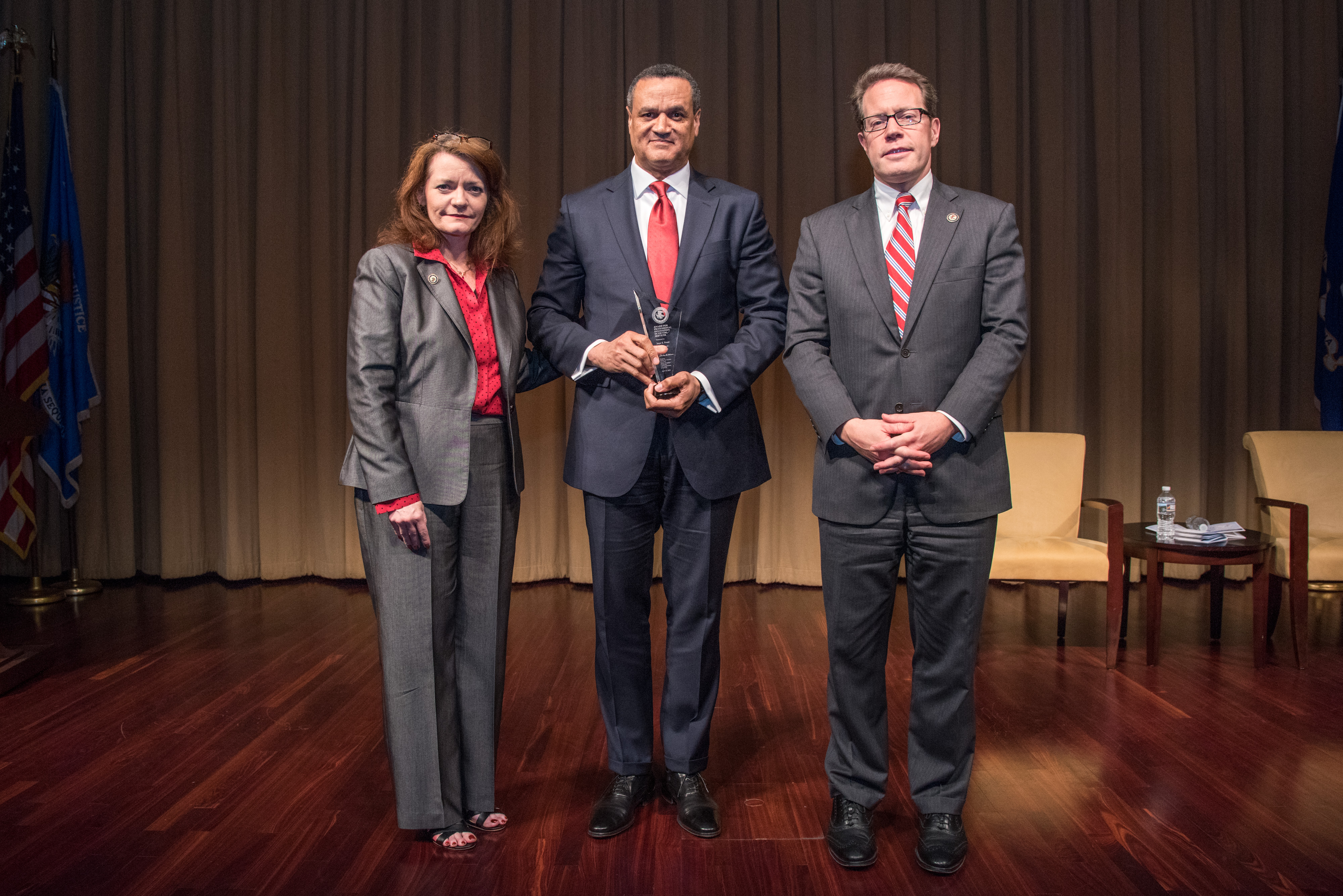 Al Stewart accepts the 2018 Award for Professional Innovation in Victim Services on behalf of the late Joye E. Frost. Pictured from left: OVC Director Darlene Hutchinson, Al Stewart, and Principal Deputy Assistant Attorney General for the Office of Justice Programs Alan Hanson.