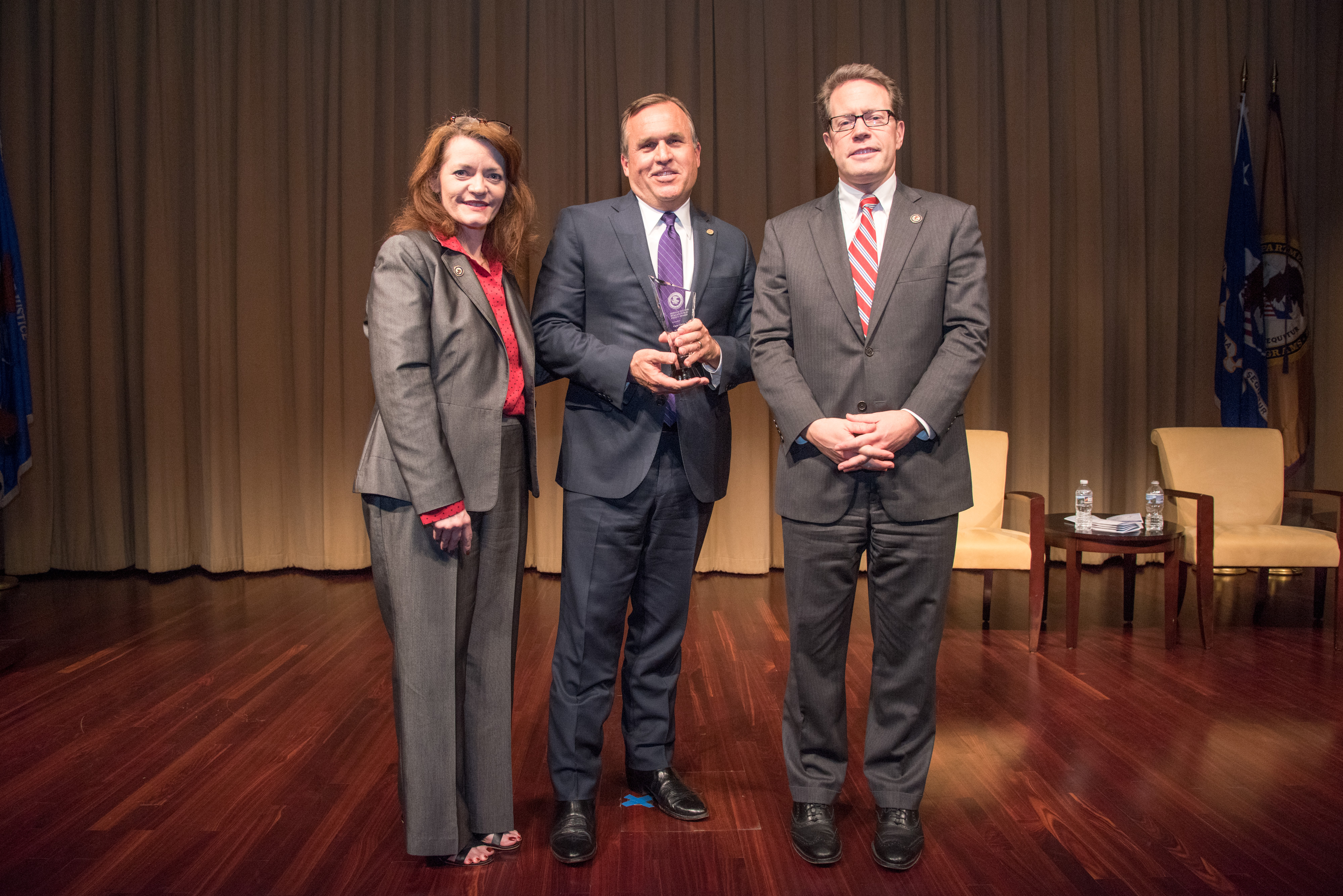2018 Ronald Wilson Reagan Public Policy Award recipient Casey Gwinn with (from left) OVC Director Darlene Hutchinson and Principal Deputy Assistant Attorney General for the Office of Justice Programs Alan Hanson.