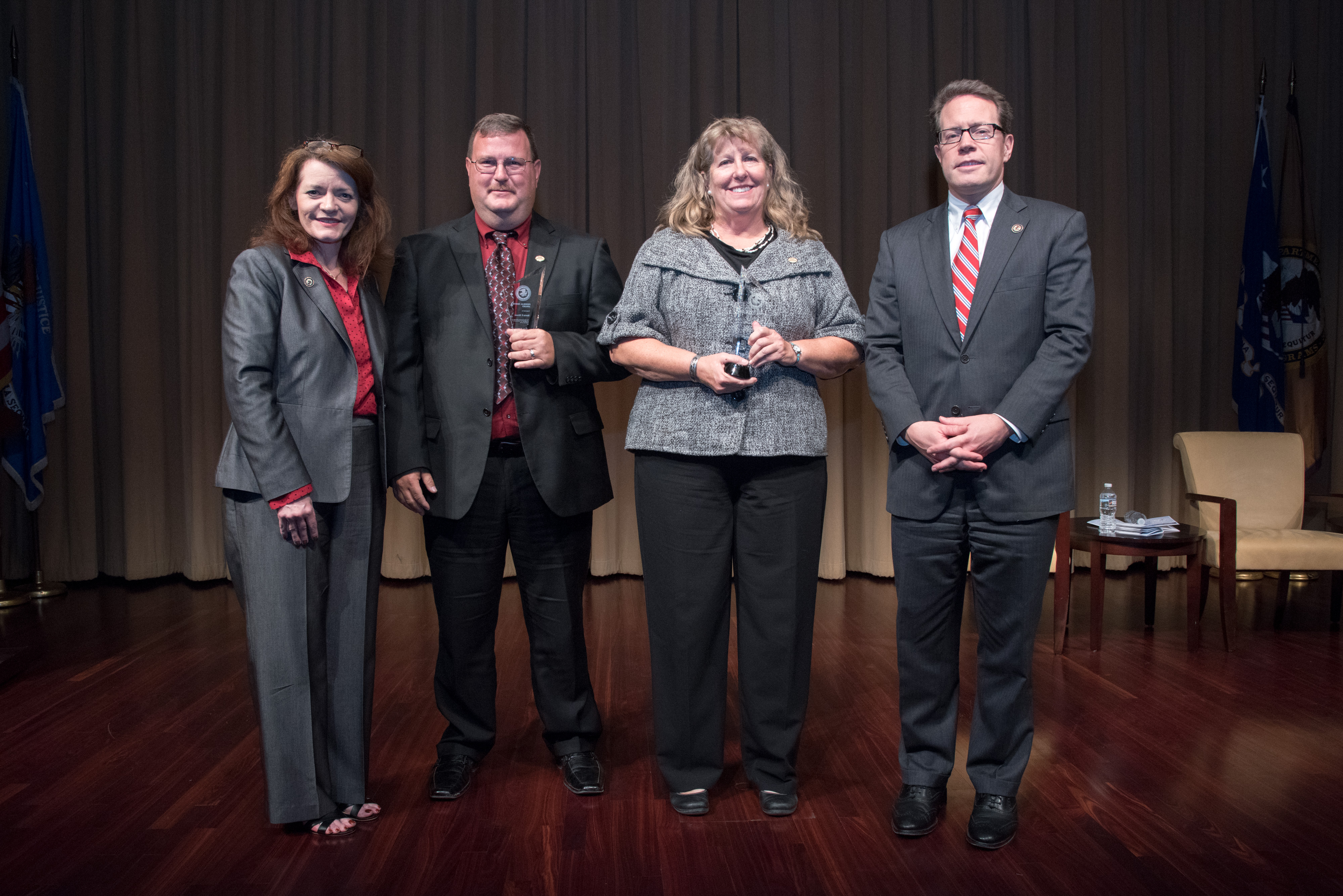 Kevin F. Rivers and Sherry C. Rice receive the 2018 Federal Service Award. Pictured from left: OVC Director Darlene Hutchinson, Kevin F. Rivers, Sherry C. Rice, and Principal Deputy Assistant Attorney General for the Office of Justice Programs Alan Hanson.