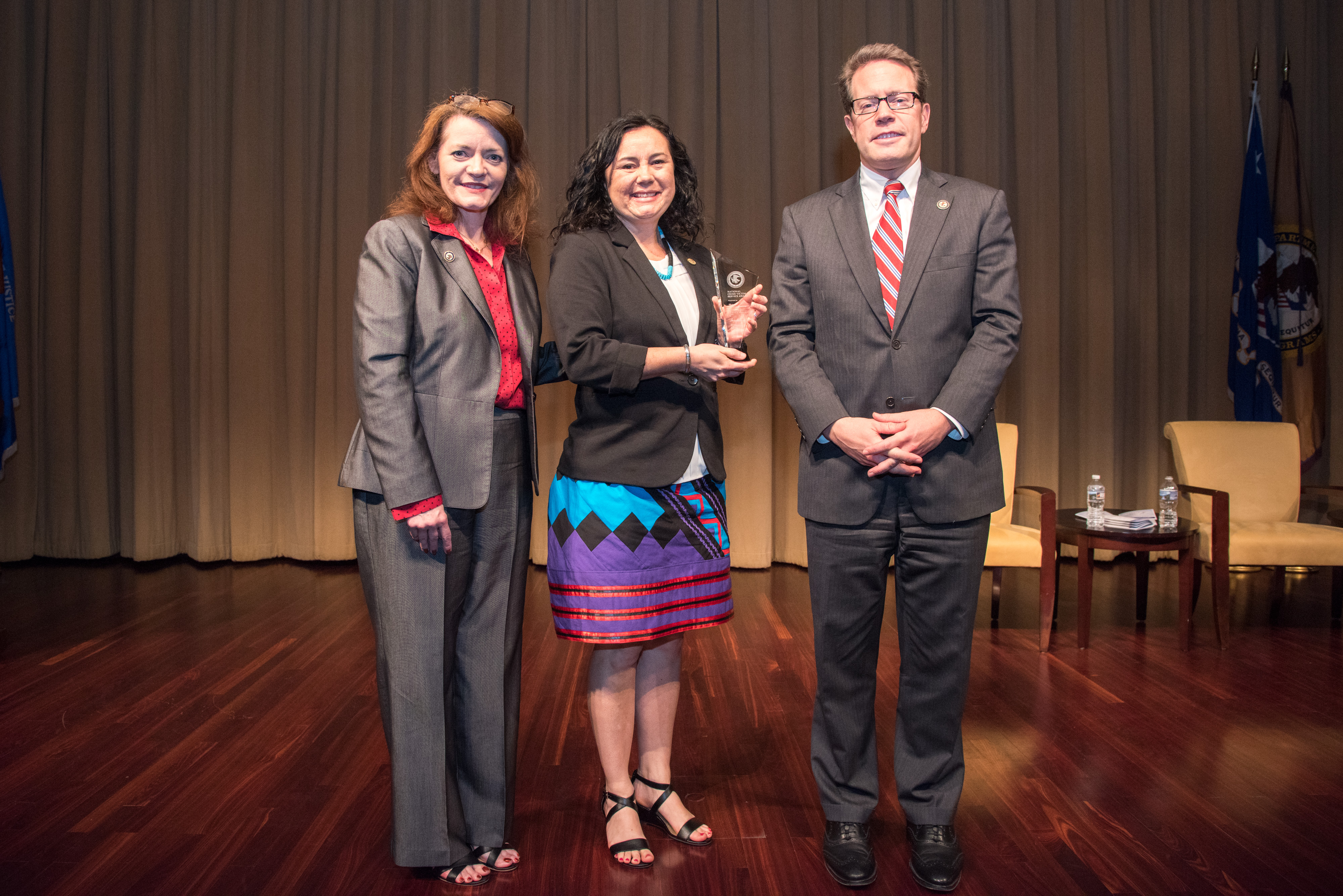 2018 National Crime Victim Service Award recipient Shawn Partridge, MSW, with (from left) OVC Director Darlene Hutchinson and Principal Deputy Assistant Attorney General for the Office of Justice Programs Alan Hanson.
