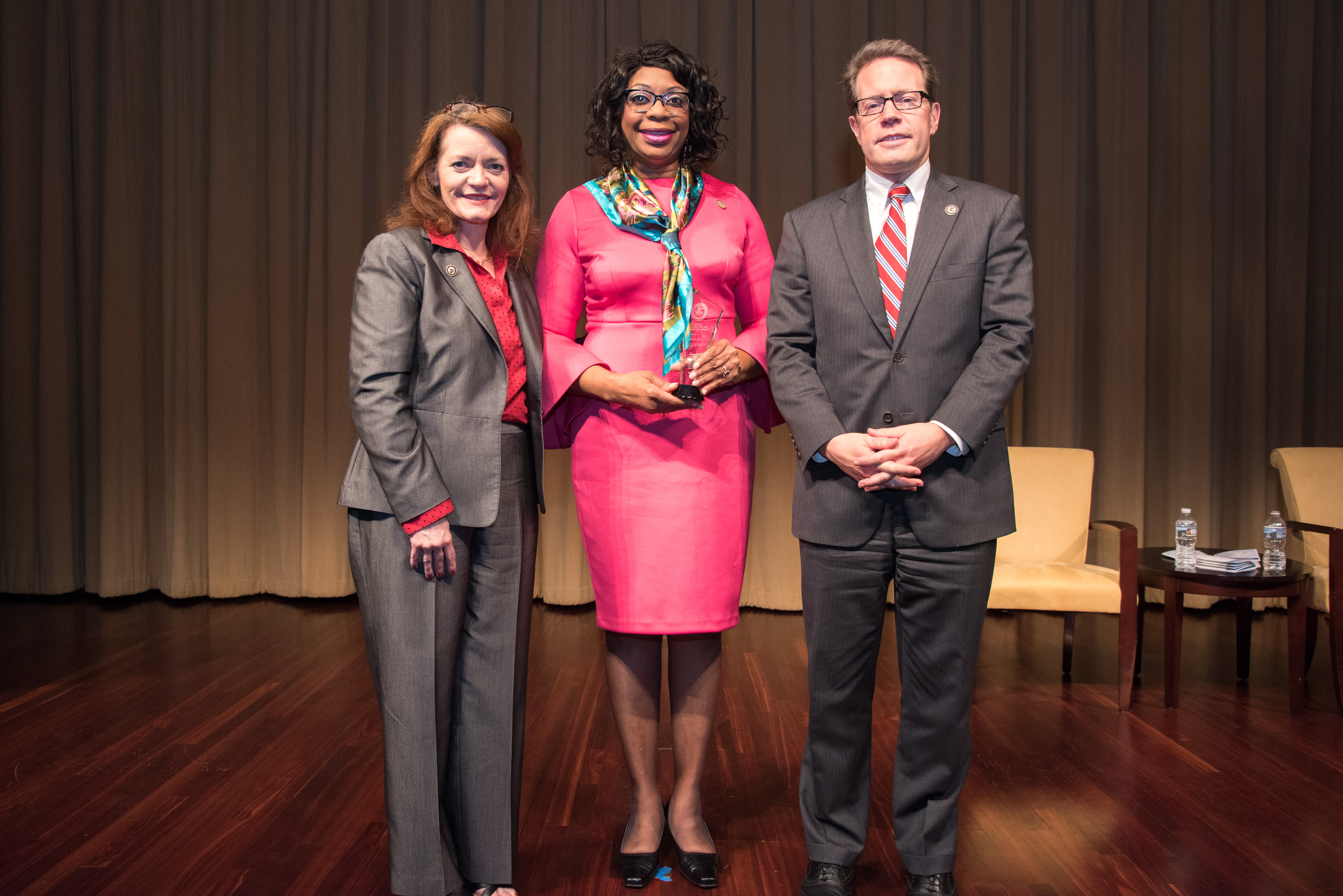 2018 National Crime Victim Service Award recipient Tina L. Fox with (from left) OVC Director Darlene Hutchinson and Principal Deputy Assistant Attorney General for the Office of Justice Programs Alan Hanson.