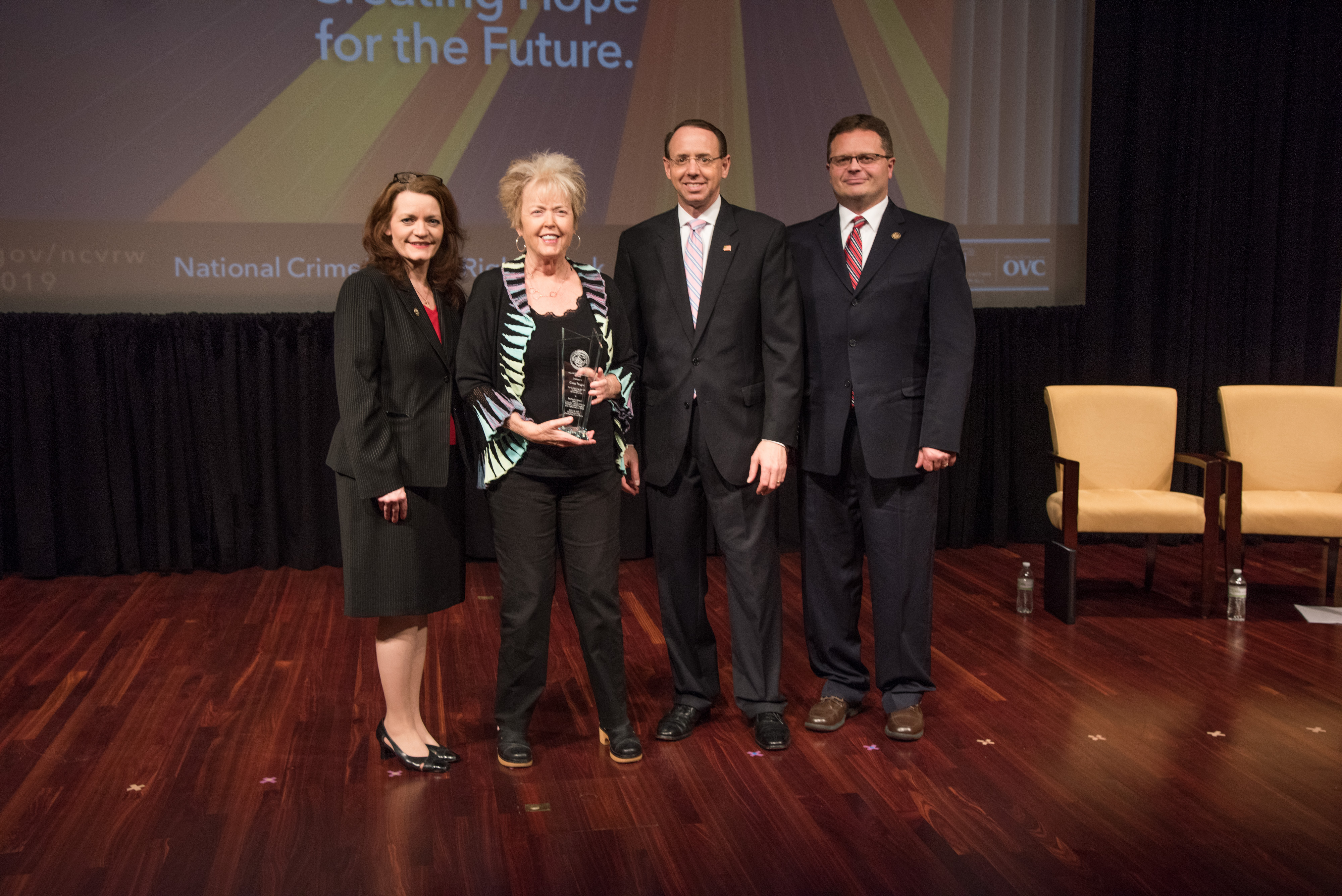 Diana Faugno receives the 2019 Allied Professional Award with (from left) OVC Director Darlene Hutchinson, Deputy Attorney General Rod J. Rosenstein, and Principal Deputy Assistant Attorney General for the Office of Justice Programs Matt M. Dummermuth.