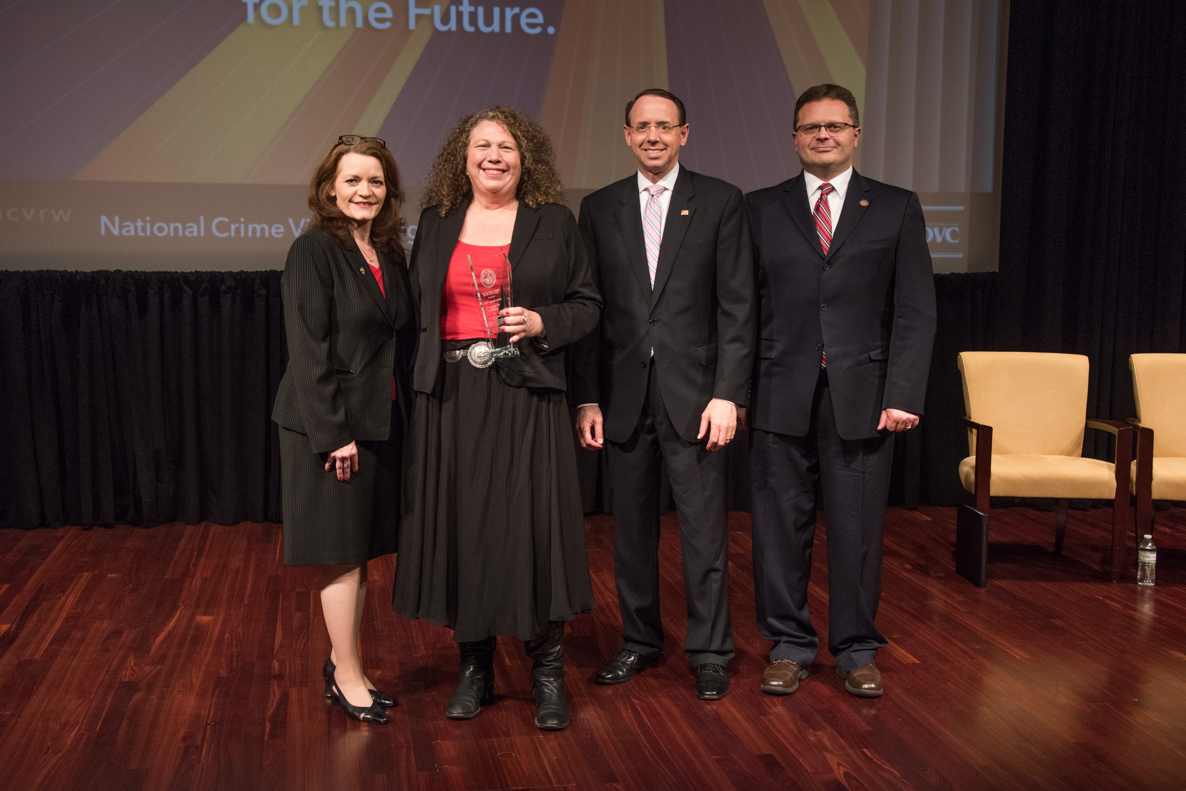 Hallie Bongar White receives the 2019 Ronald Wilson Reagan Public Policy Award with (from left) OVC Director Darlene Hutchinson, Deputy Attorney General Rod J. Rosenstein, and Principal Deputy Assistant Attorney General for the Office of Justice Programs Matt M. Dummermuth.