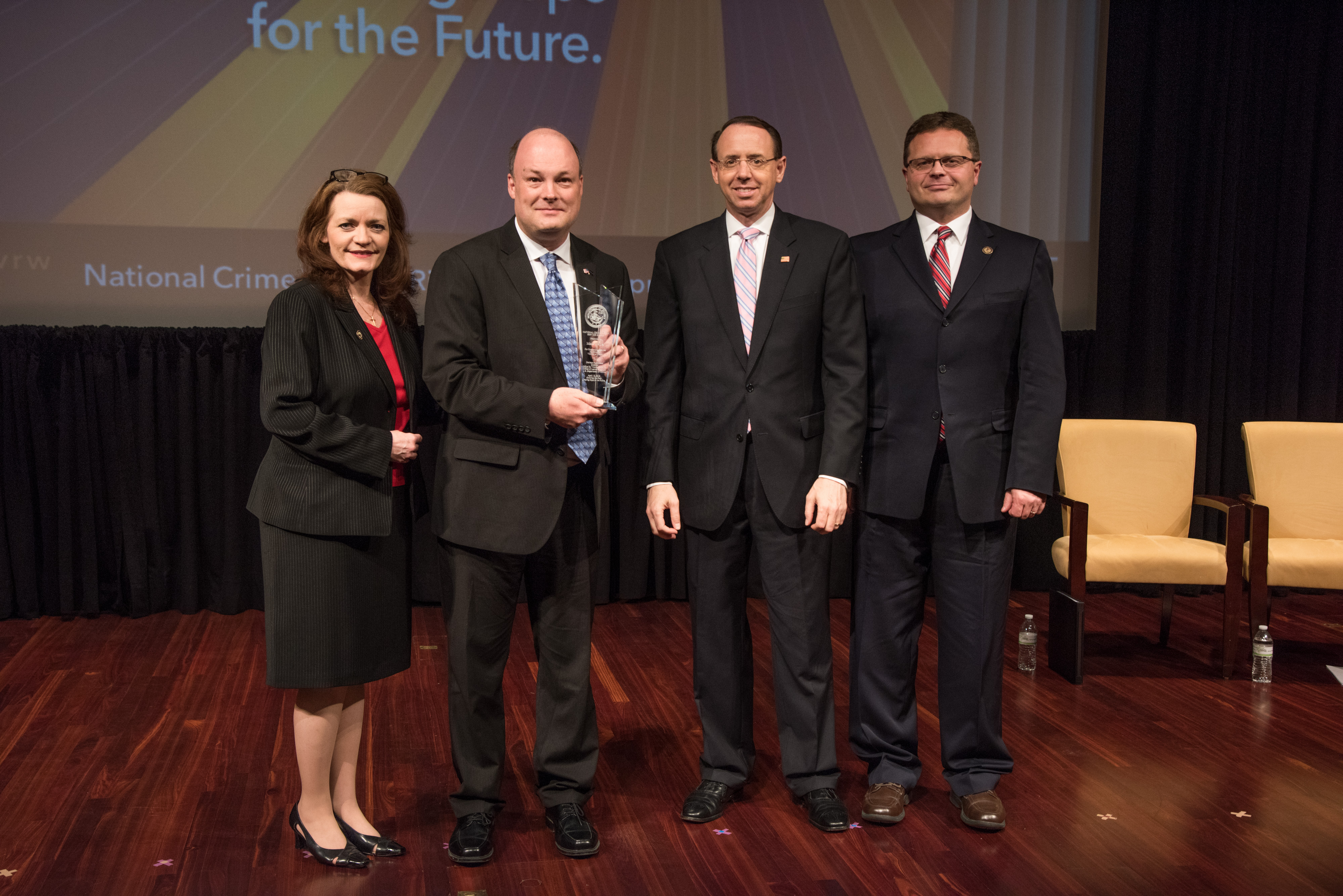 Mark J. Weiner receives the 2019 National Crime Victim Service Award with (from left) OVC Director Darlene Hutchinson, Deputy Attorney General Rod J. Rosenstein, and Principal Deputy Assistant Attorney General for the Office of Justice Programs Matt M. Dummermuth.