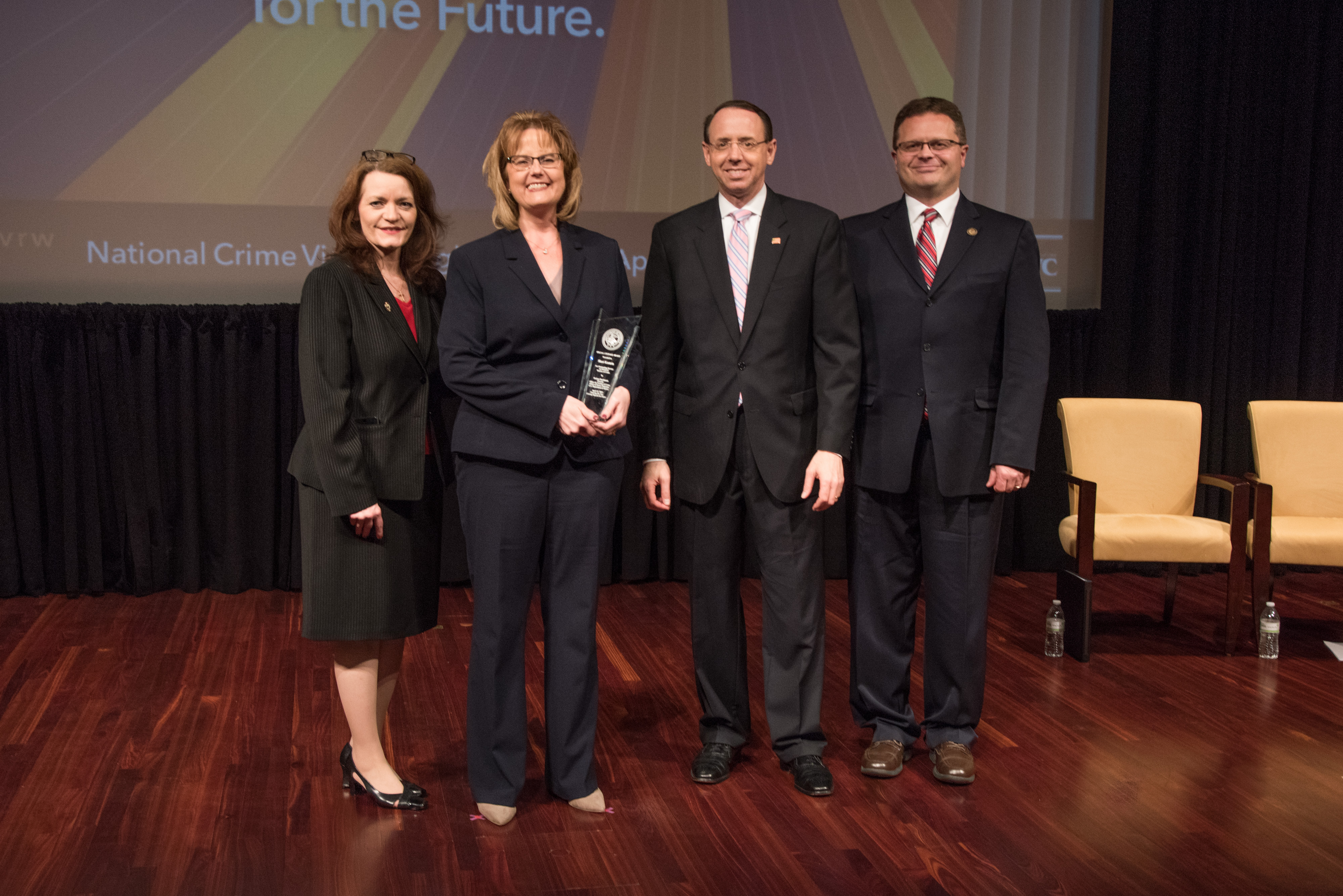 Shari Kastein receives the 2019 Special Courage Award with (from left) OVC Director Darlene Hutchinson, Principal Deputy Assistant Attorney General for the Office of Justice Programs Matt M. Dummermuth, and Deputy Attorney General Rod J. Rosenstein.