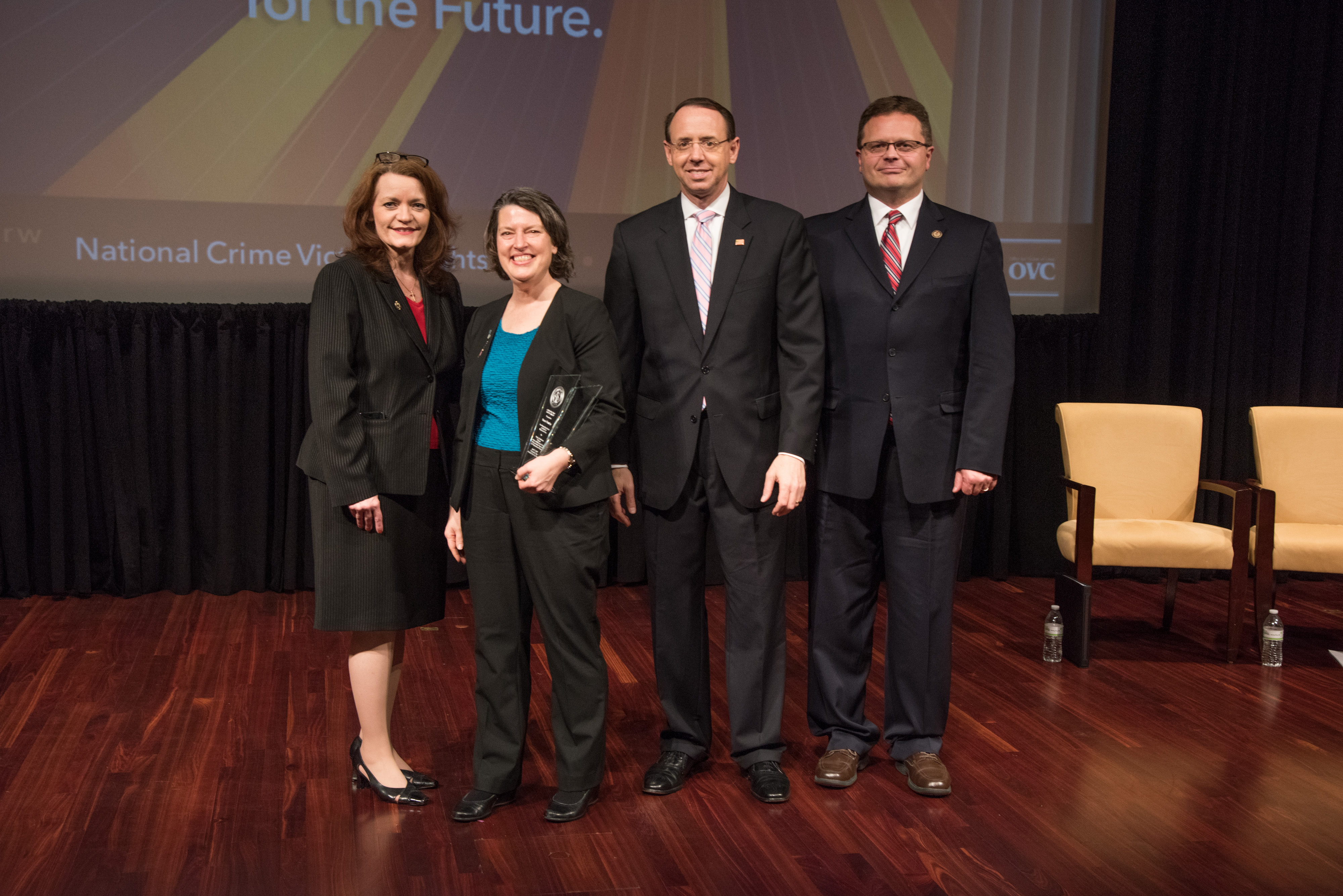 Susan Howley receives the 2019 Crime Victims’ Rights Award with (from left) OVC Director Darlene Hutchinson, Principal Deputy Assistant Attorney General for the Office of Justice Programs Matt M. Dummermuth, and Deputy Attorney General Rod J. Rosenstein.