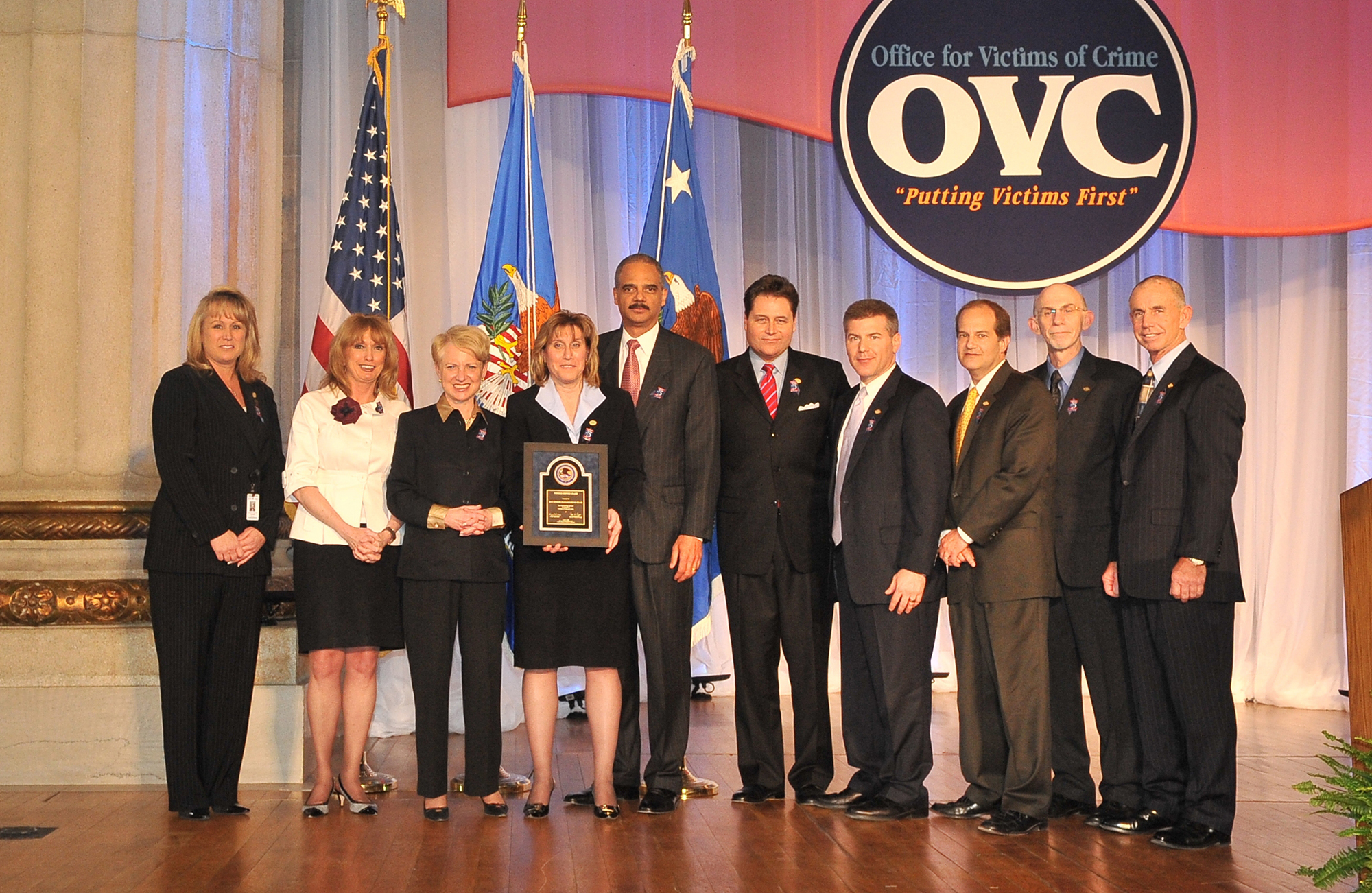 The U.S. Immigration and Customs Enforcement Senior Management Team accepts an award from (left) Joye E. Frost, Acting Director, Office for Victims of Crime; Laurie O. Robinson, Acting Assistant Attorney General, Office of Justice Programs; and U.S. Attorney General Eric H. Holder, Jr.