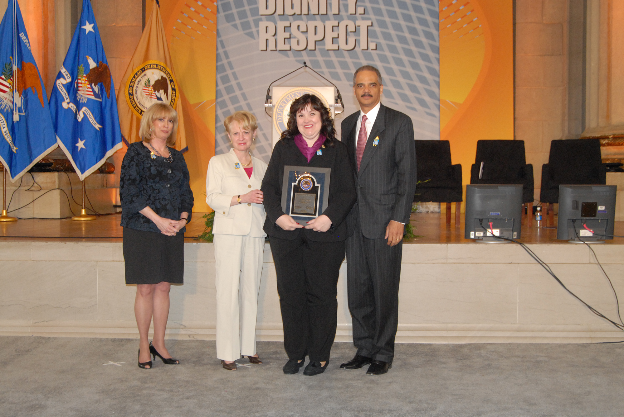 2010 Volunteer for Victims Award recipient Kelly Jolkowski with (from left) Joye E. Frost, Acting Director, Office for Victims of Crime; Assistant Attorney General Laurie O. Robinson, Office of Justice Programs; and U.S. Attorney General Eric H. Holder, Jr.