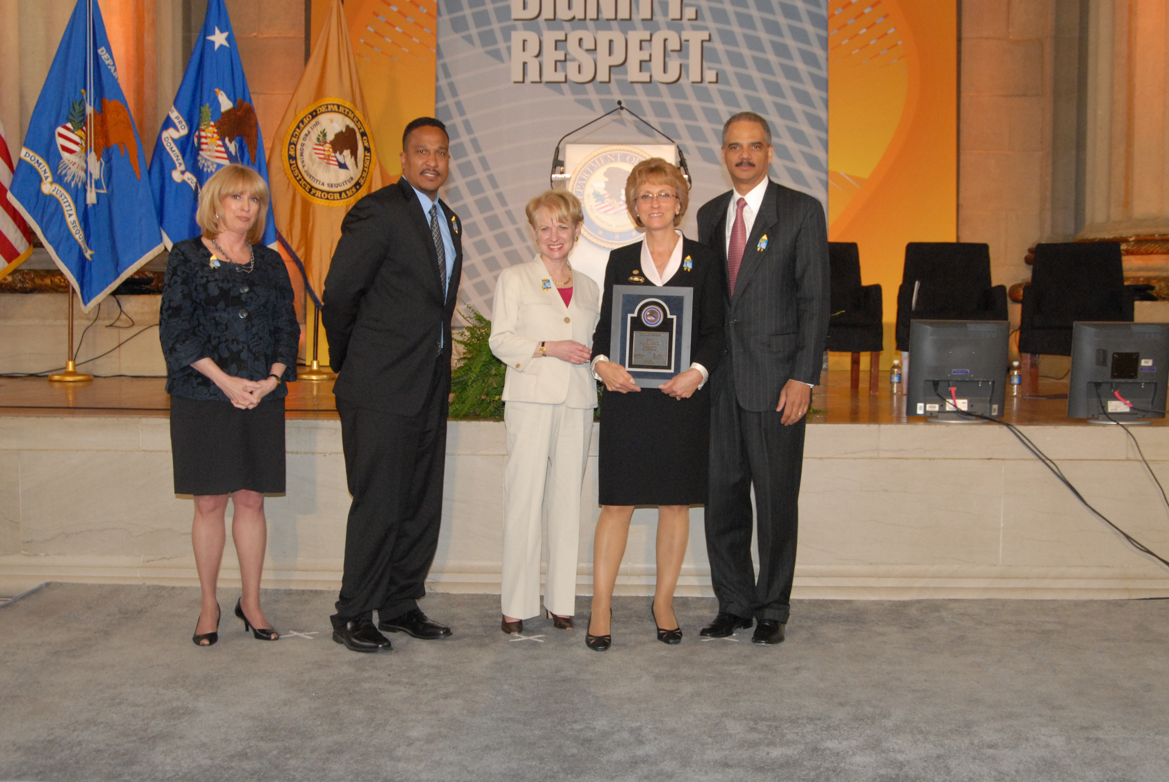 2010 Federal Service Award recipient Marcia L. Rinker with (from left) Joye E. Frost, Acting Director, Office for Victims of Crime; Ronald C. Machen, Jr., United States Attorney for the District of Columbia; Assistant Attorney General Laurie O. Robinson, Office of Justice Programs; and U.S. Attorney General Eric H. Holder, Jr.