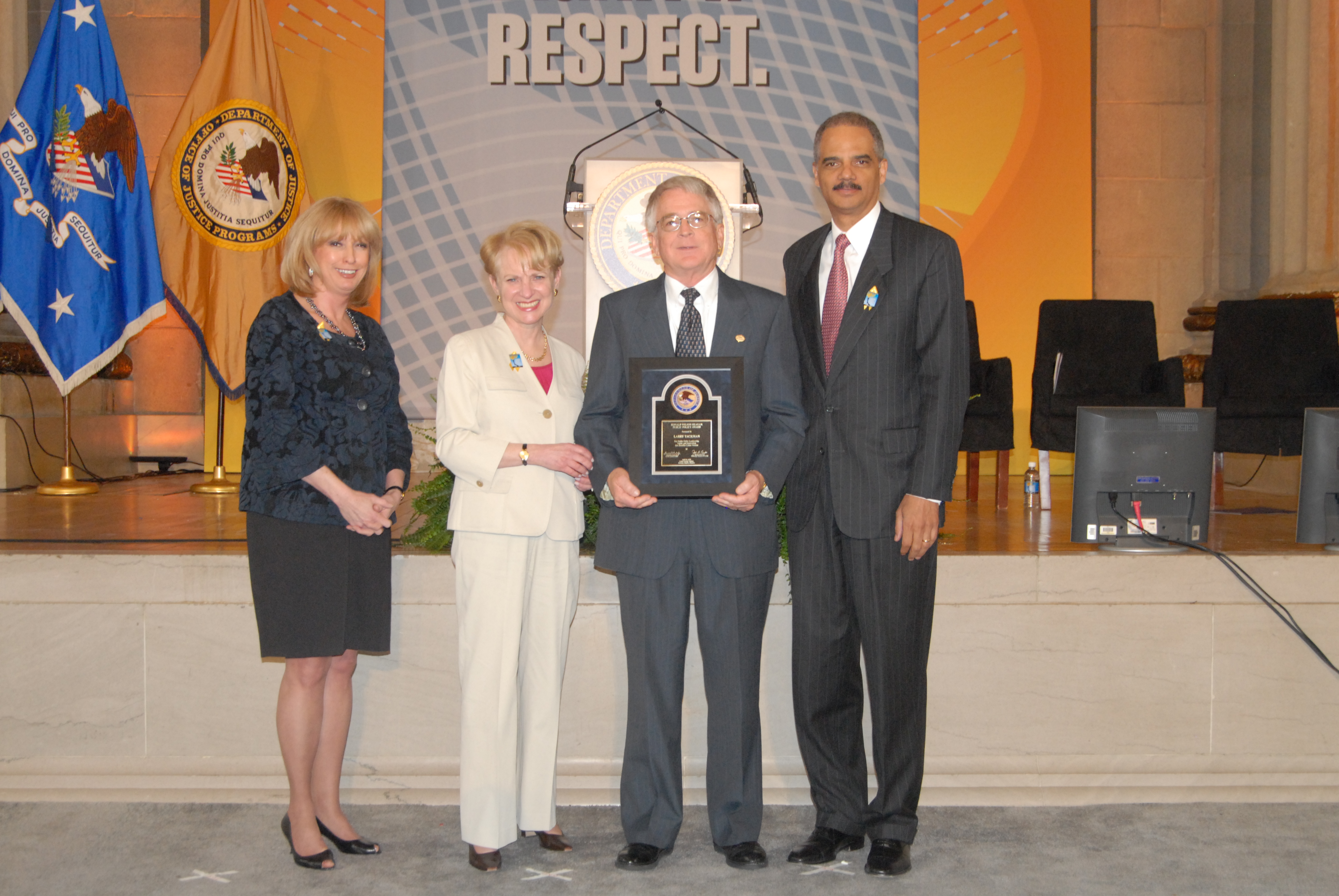 2010 Ronald Wilson Reagan Public Policy Award recipient Larry Tackman with (from left) Joye E. Frost, Acting Director, Office for Victims of Crime; Assistant Attorney General Laurie O. Robinson, Office of Justice Programs; and U.S. Attorney General Eric H. Holder, Jr.