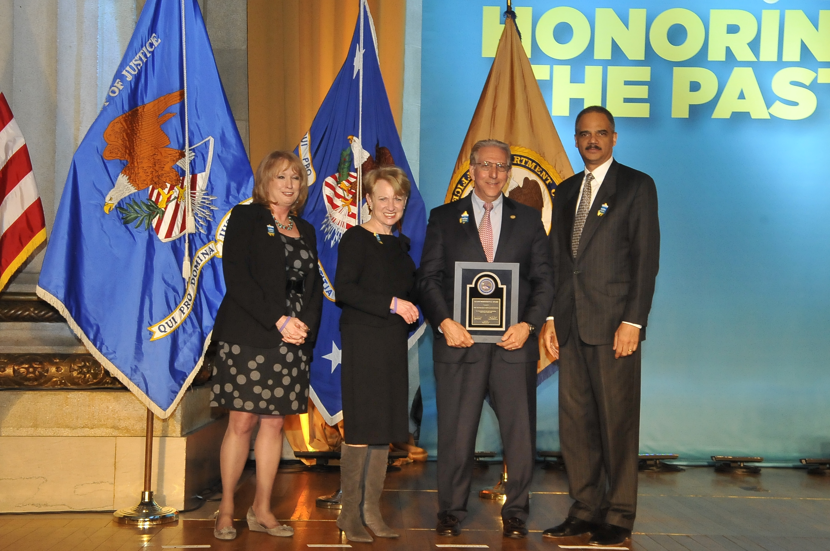 The Honorable Ronald Reinstein receives the 2011 Allied Professional Award with (from left) Joye E. Frost, Acting Director, Office for Victims of Crime; Assistant Attorney General Laurie O. Robinson, Office of Justice Programs; and U.S. Attorney General Eric H. Holder, Jr.