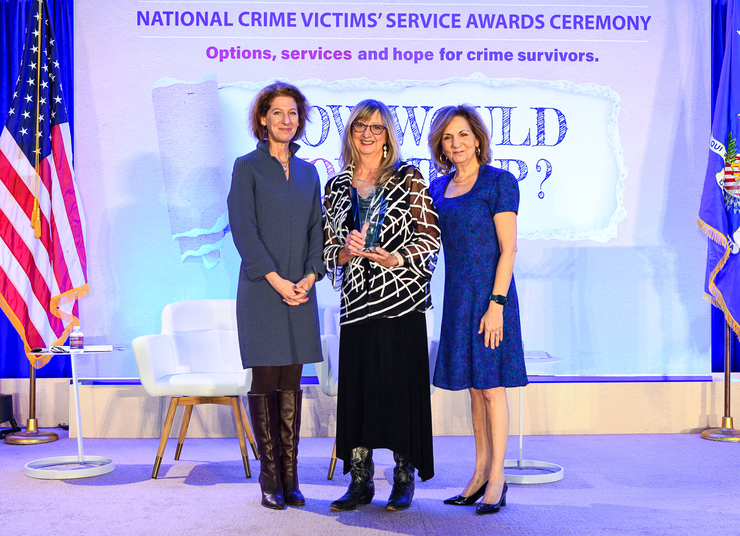 Angela McCown, LMFT receives the 2024 National Crime Victim Service Award with (from left) OVC Director Kristina Rose and Assistant Attorney General Amy L. Solomon.
