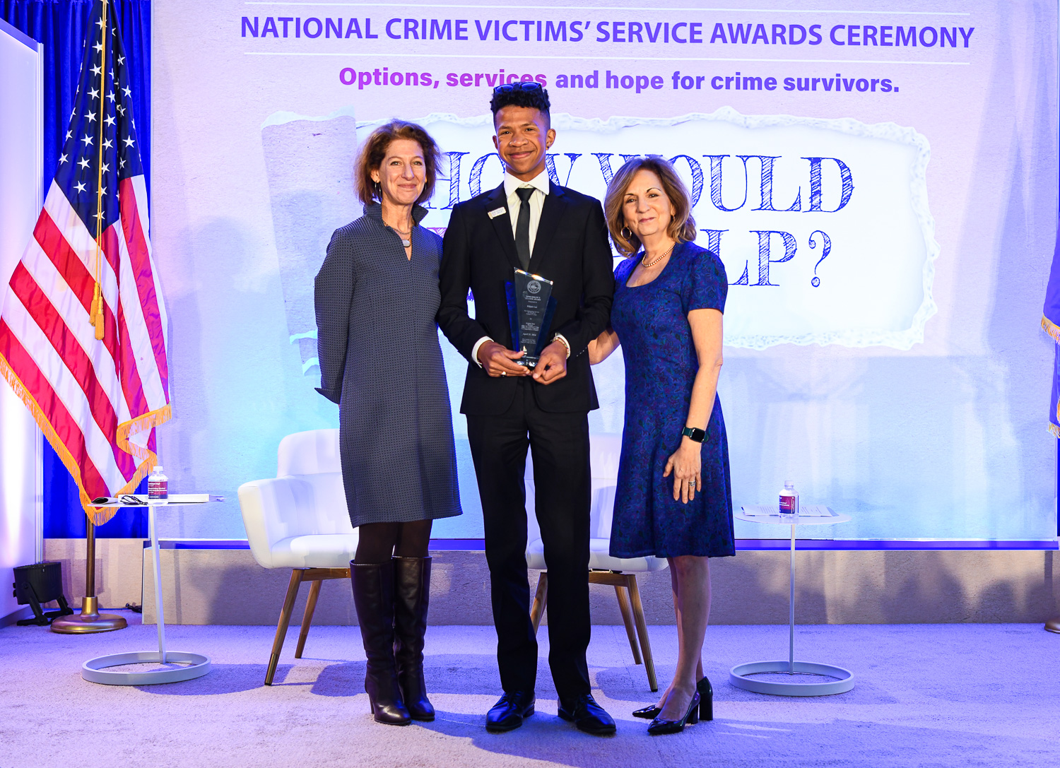 Elijah Lee receives the 2024 Tomorrow’s Leader Award with (from left) OVC Director Kristina Rose and Assistant Attorney General Amy L. Solomon.