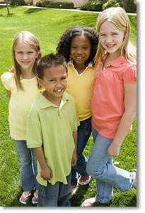 Photo of a group of four children smiling