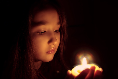 Young girl holding candle