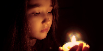 Young girl holding candle