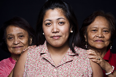 Three women, smiling