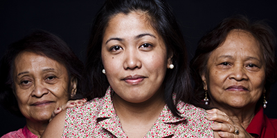 Three women, smiling