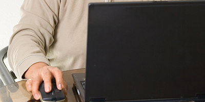woman sitting at laptop computer, smiling