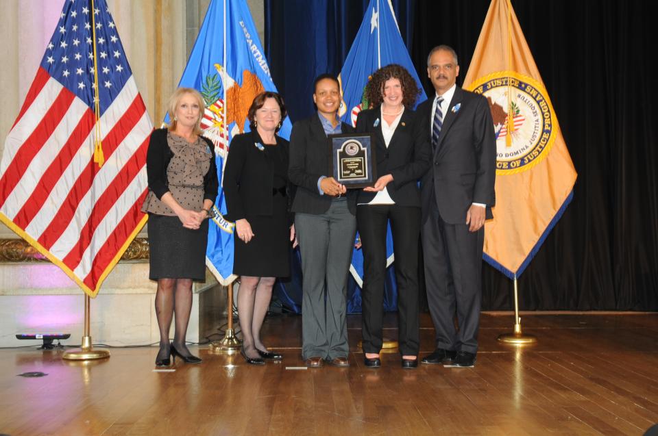 Shameeka Mattis and Danielle Sered accept the 2012 Award for Professional Innovation in Victim Services on behalf of Common Justice with (from left) Joye E. Frost, Acting Director, Office for Victims of Crime; Acting Assistant Attorney General Mary Lou Leary, Office of Justice Programs; and U.S. Attorney General Eric H. Holder, Jr.
