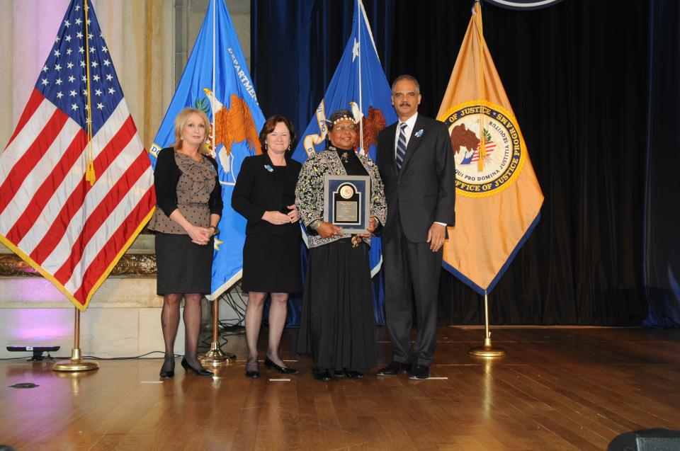 2012 National Crime Victim Service Award recipient Victoria Cruz with (from left) Joye E. Frost, Acting Director, Office for Victims of Crime; Acting Assistant Attorney General Mary Lou Leary, Office of Justice Programs; and U.S. Attorney General Eric H. Holder, Jr.