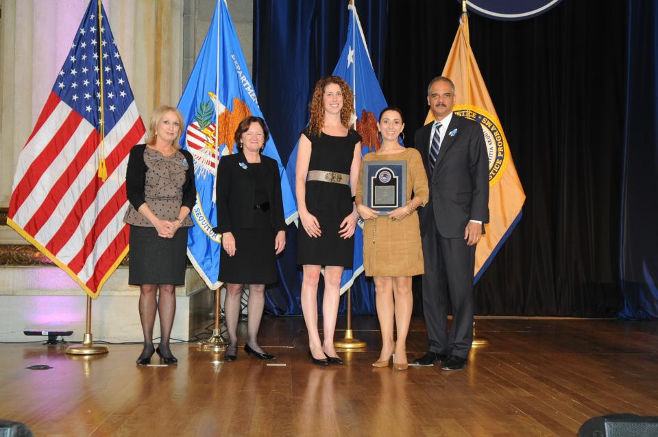 Rachel Lloyd accepts the 2012 National Crime Victim Service Award for Girls Educational and Mentoring Services accompanied by Janice Holzman with Joye E. Frost, Acting Director, Office for Victims of Crime; Acting Assistant Attorney General Mary Lou Leary, Office of Justice Programs; and U.S. Attorney General Eric H. Holder, Jr.