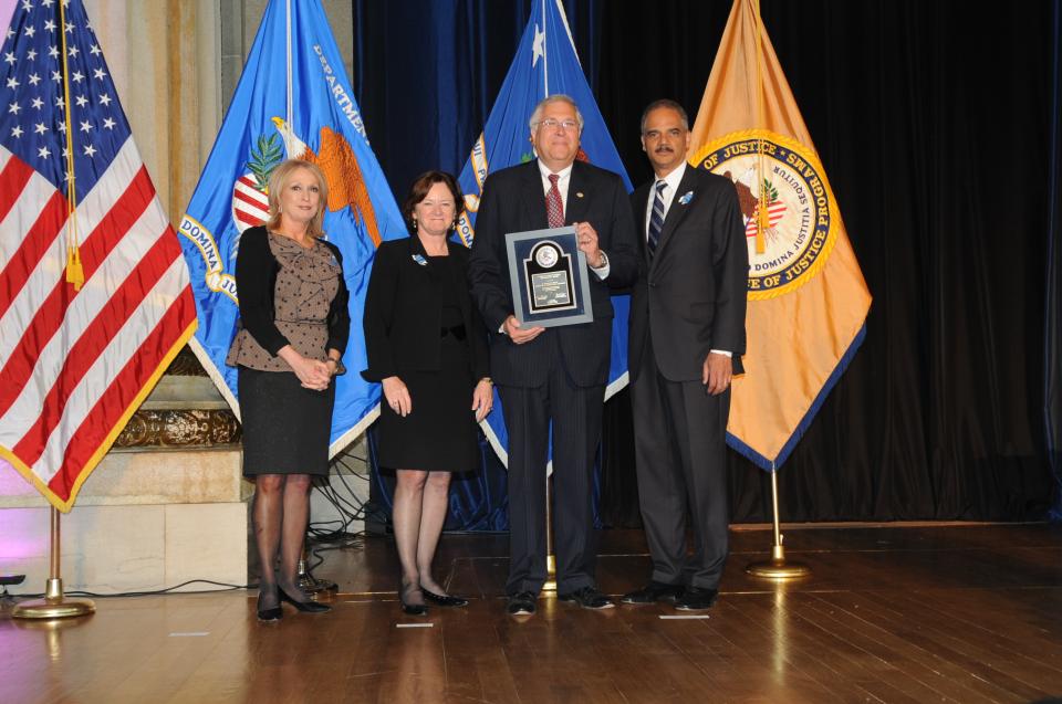 2012 Crime Victims Financial Restoration Award recipient G. Wingate Grant with (from left) Joye E. Frost, Acting Director, Office for Victims of Crime; Acting Assistant Attorney General Mary Lou Leary, Office of Justice Programs; and U.S. Attorney General Eric H. Holder, Jr.