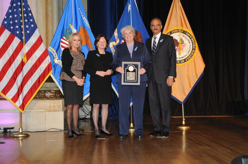 2012 Federal Service Award recipient Roi Holt with (from left) Joye E. Frost, Acting Director, Office for Victims of Crime; Acting Assistant Attorney General Mary Lou Leary, Office of Justice Programs; and U.S. Attorney General Eric H. Holder, Jr.