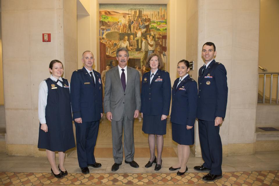 Staff from the U.S. Air Force Special Victims’ Counsel Program, a 2014 Federal Service Award recipient, appear with Deputy Attorney General James M. Cole.