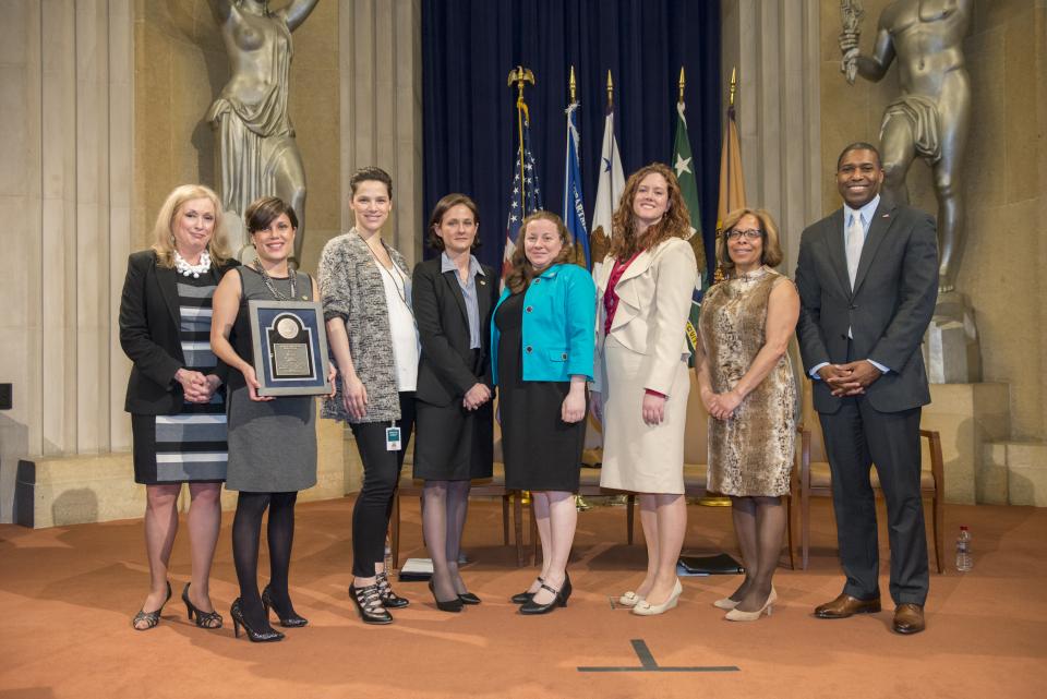 Natalia Marlow Otero, Andrea Sledd, Elisabeth Olds, Jennifer Wesberry, and Baylis Beard accept the 2014 National Crime Victim Service Award for DC SAFE, with Joye E. Frost, Director, Office for Victims of Crime; Karol V. Mason, Assistant Attorney General, Office of Justice Programs; and Associate Attorney General Tony West.