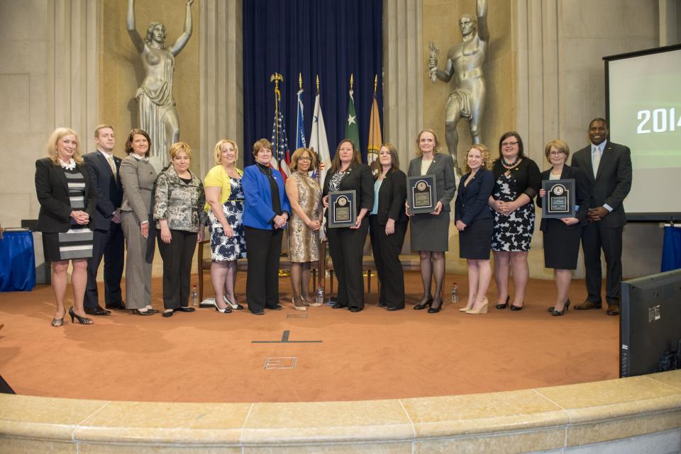 Staff from the Federal Bureau of Investigation Victim Assistance Program and U.S. Attorney's Office for the District of Massachusetts accept the 2014 Federal Service Award.