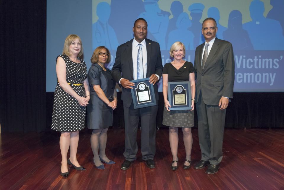 2015 National Crime Victim Service Award recipients Ronald Cotton and Jennifer Thompson with (from left) Joye E. Frost, Director, Office for Victims of Crime; Karol V. Mason, Assistant Attorney General, and Attorney General Eric H. Holder, Jr.