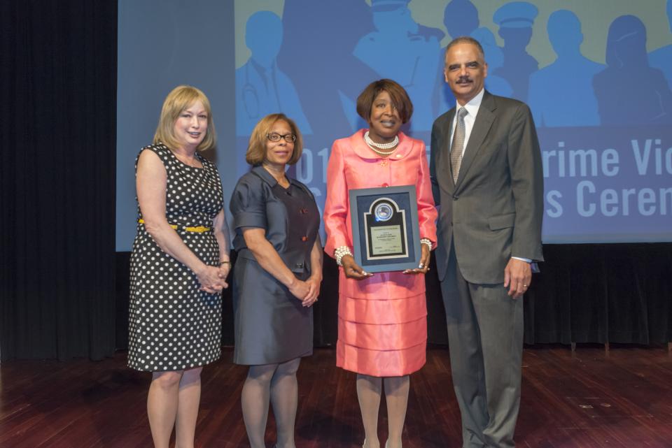 2015 National Crime Victim Service Award recipient LaWanda Hawkins with (from left) Joye E. Frost, Director, Office for Victims of Crime; Karol V. Mason, Assistant Attorney General, and Attorney General Eric H. Holder, Jr.