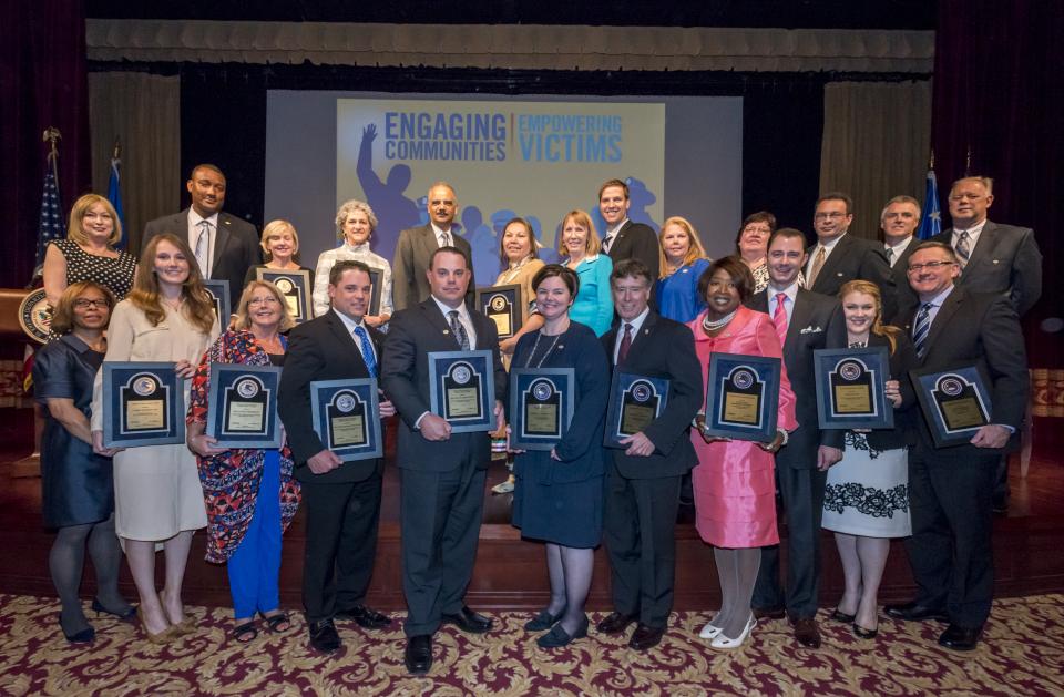 The 2015 National Crime Victims' Service Awards recipients with Attorney General Eric H. Holder, Jr., Assistant Attorney General Karol V. Mason, and OVC Director Joye E. Frost.